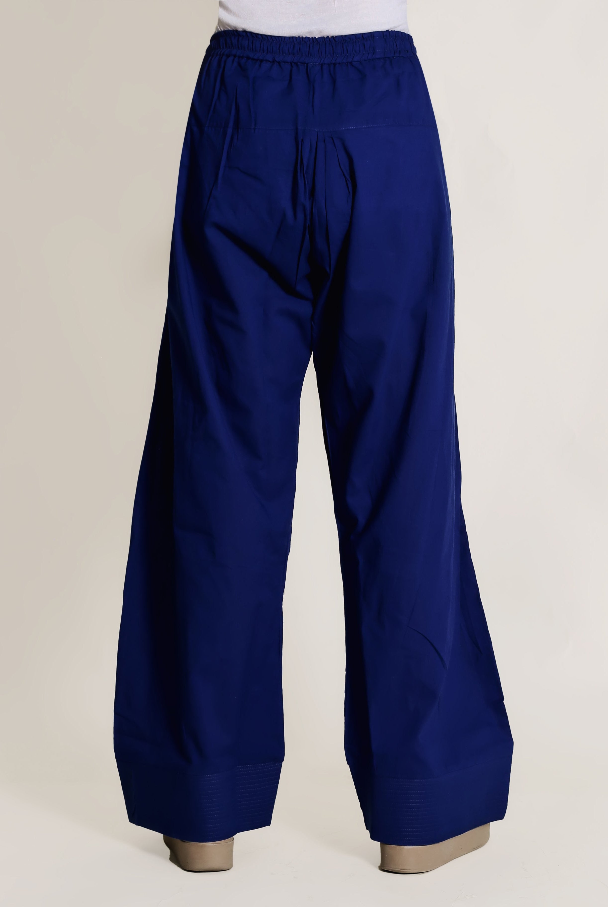 Royal blue wide-leg pants with elastic waistband and plain fabric, on a model from behind.