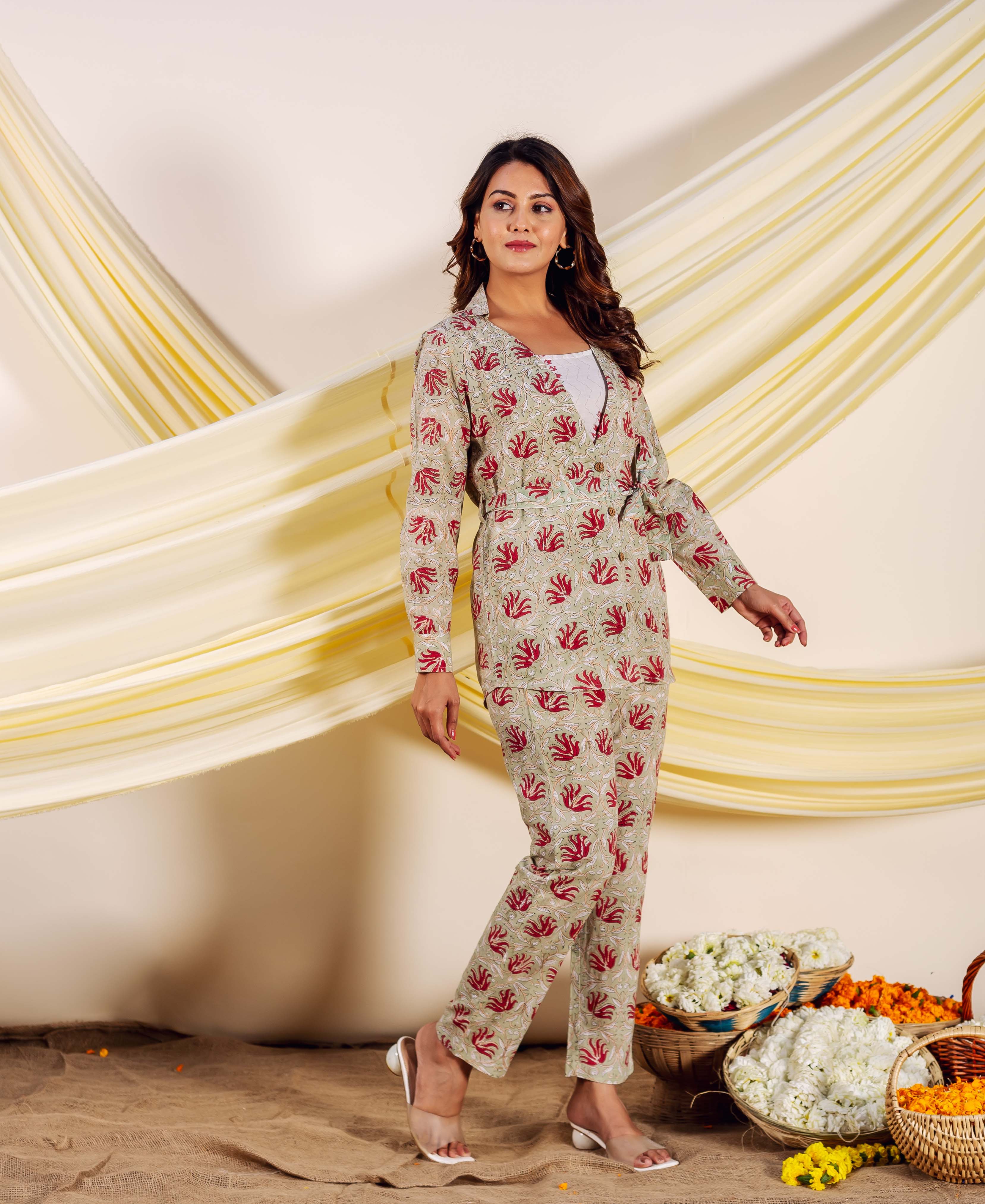 Model in a beige hand-block-printed ethnic co-ord set with red leaf motifs.