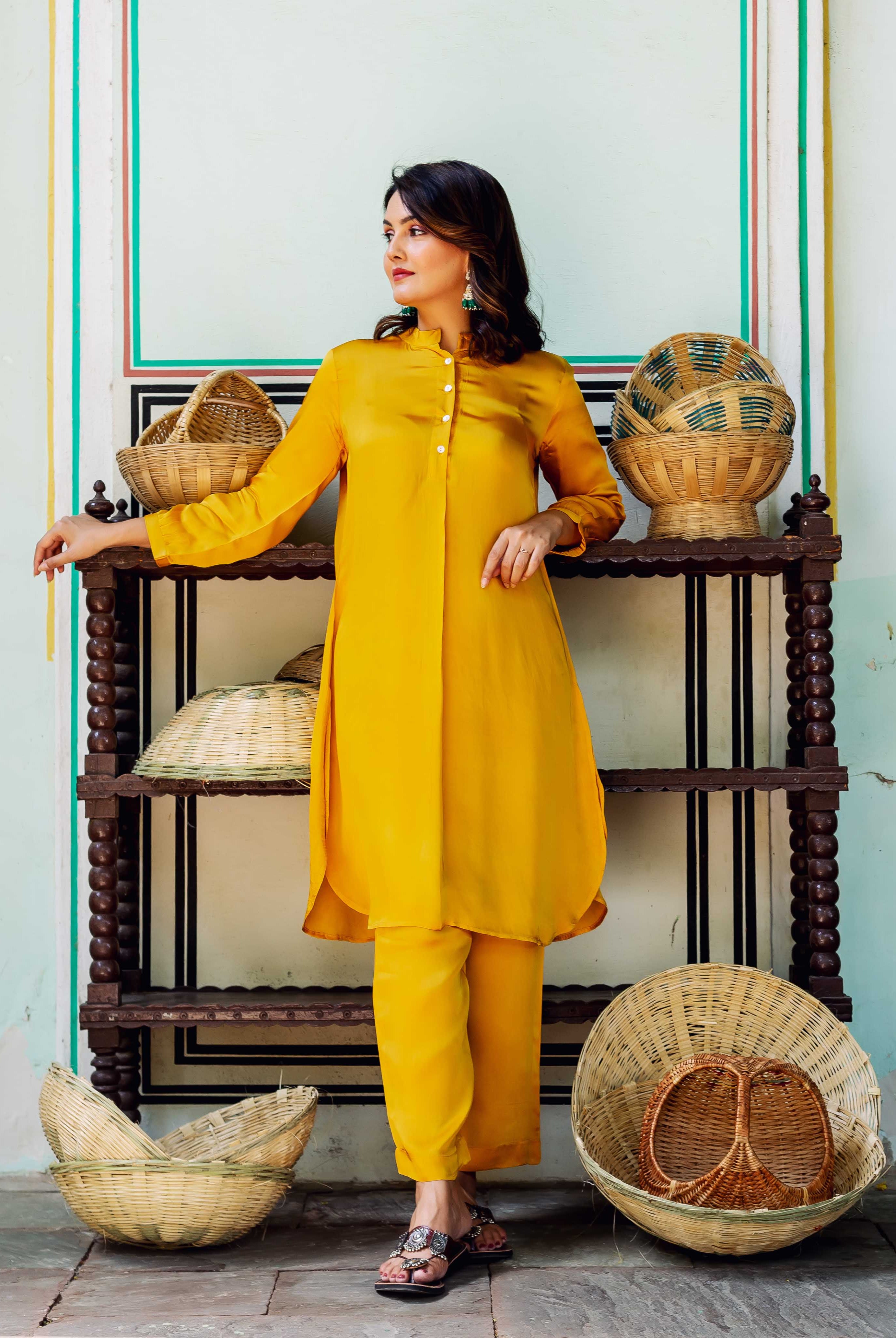 Model in golden yellow satin coord set, full look, front-side view.