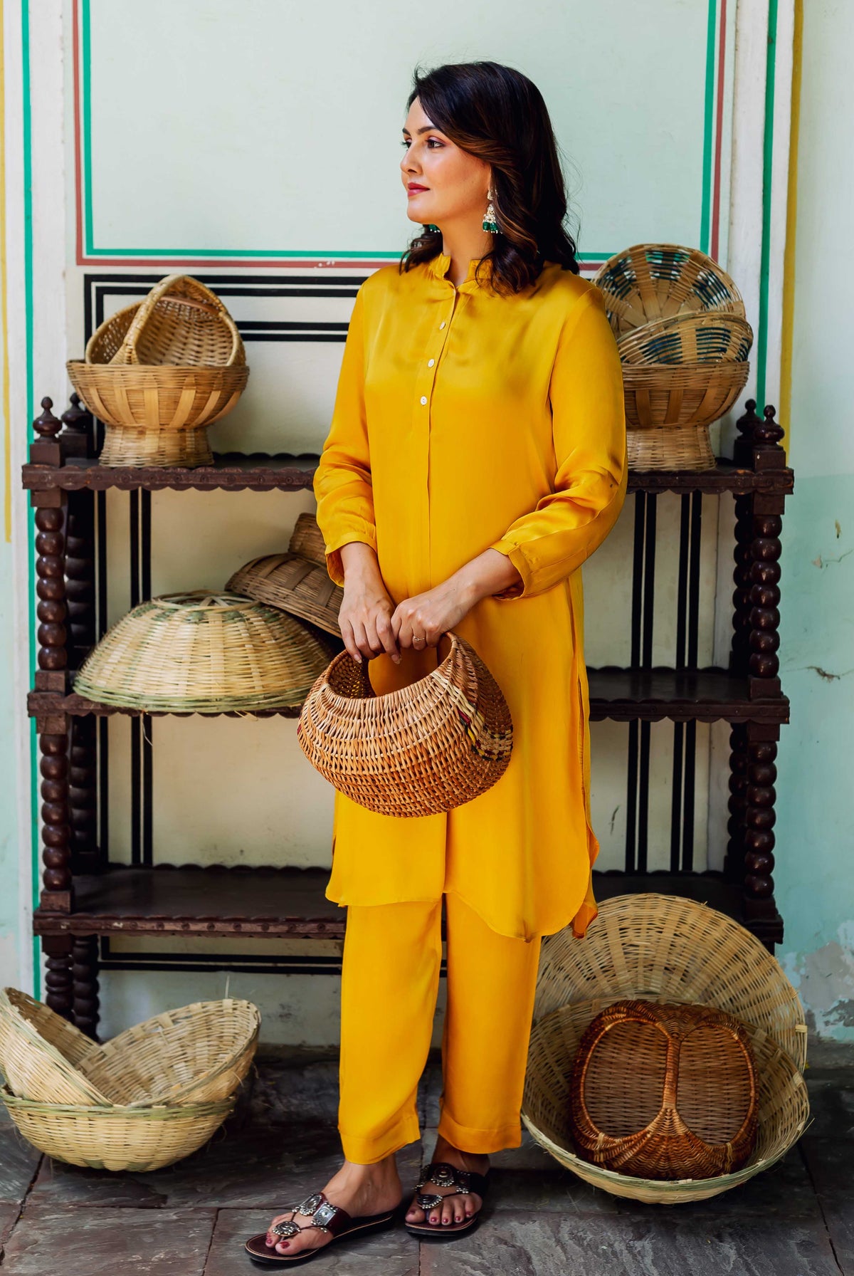 Front view of model in a luminous golden yellow satin coord set.