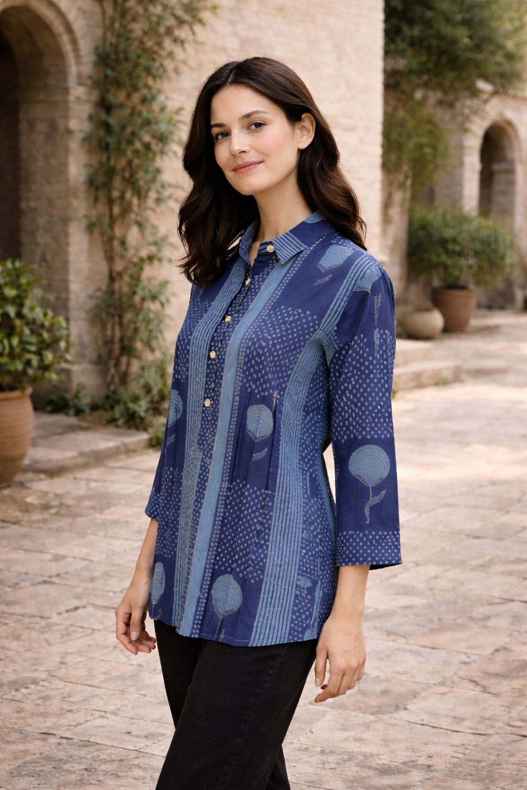 Model wearing a midnight blue hand-printed tunic with abstract floral and dot patterns.