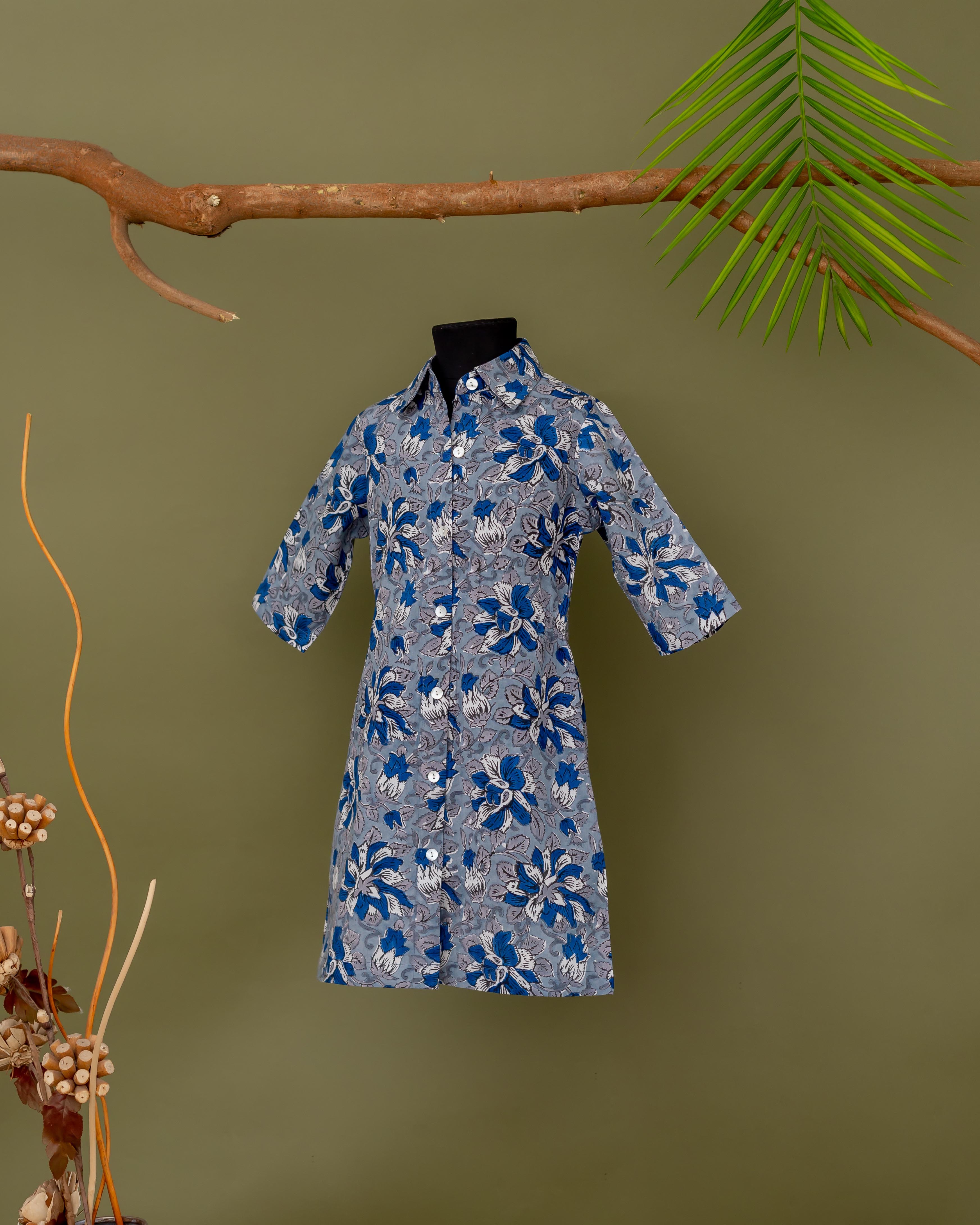 Front view of a baby girl's blue and grey floral hand-block printed dress on mannequin.