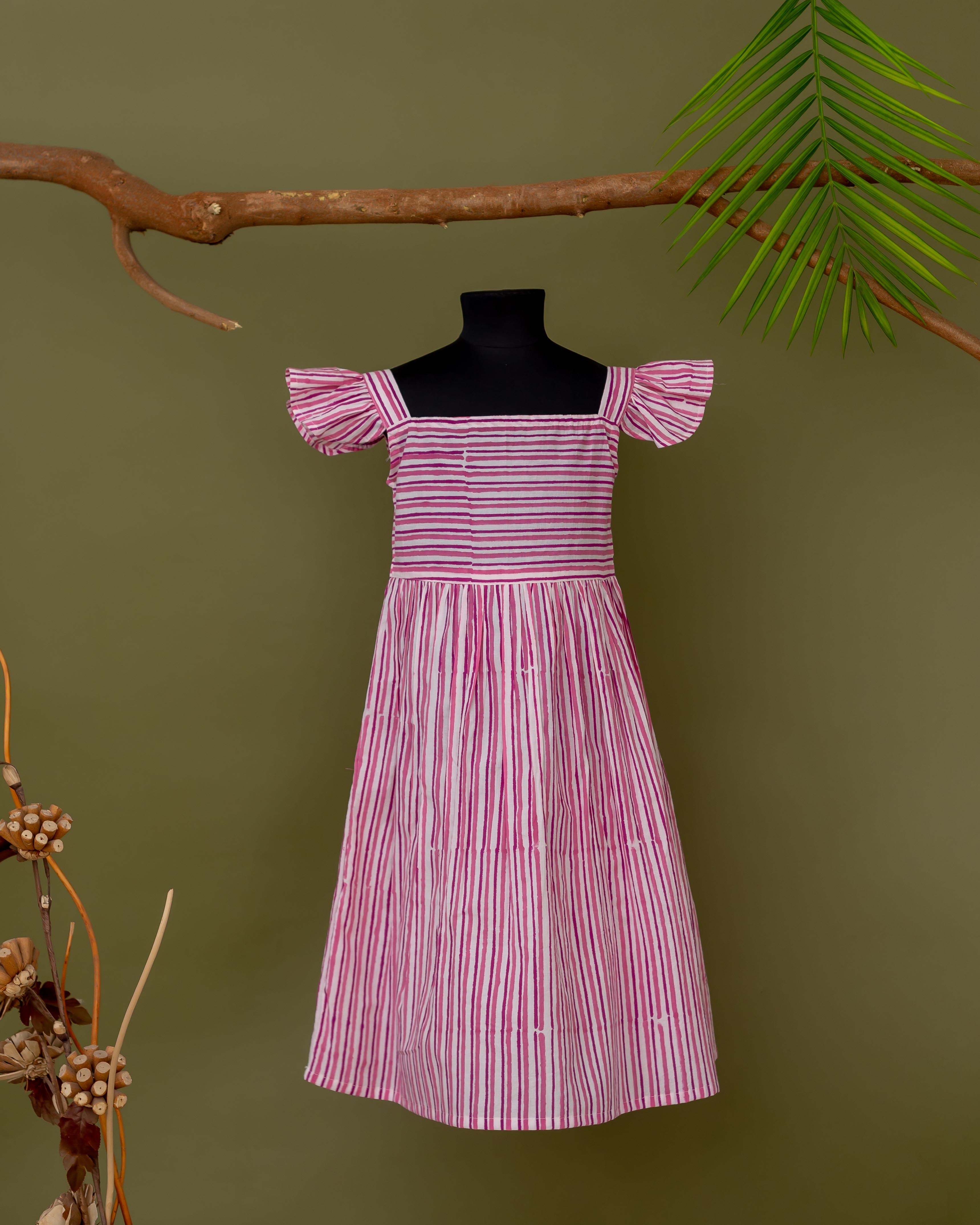 Pink and white striped hand block printed dress on mannequin, off-shoulder style.