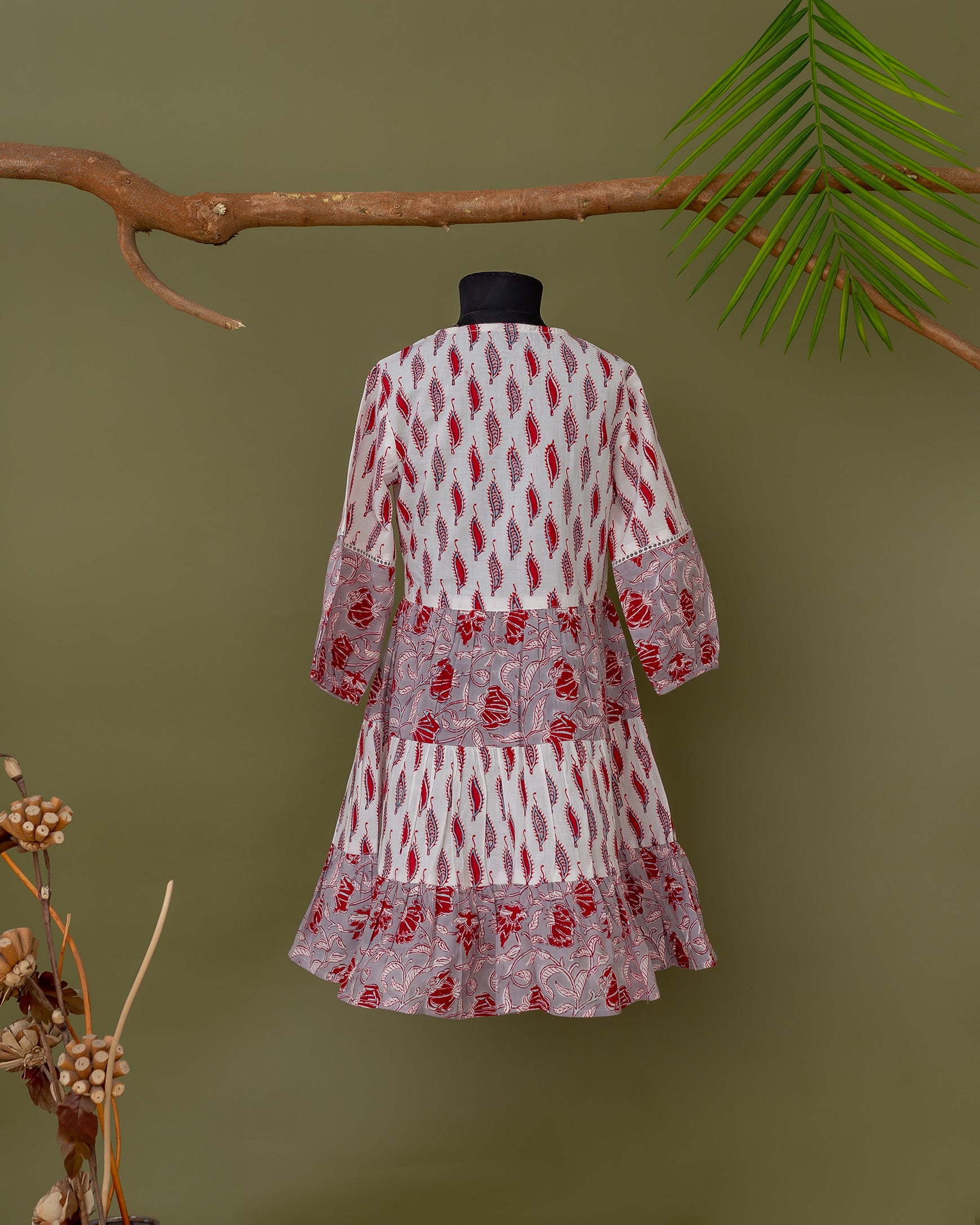 Grey and pink tiered dress with hand-block-printed ethnic design, displayed on a mannequin.