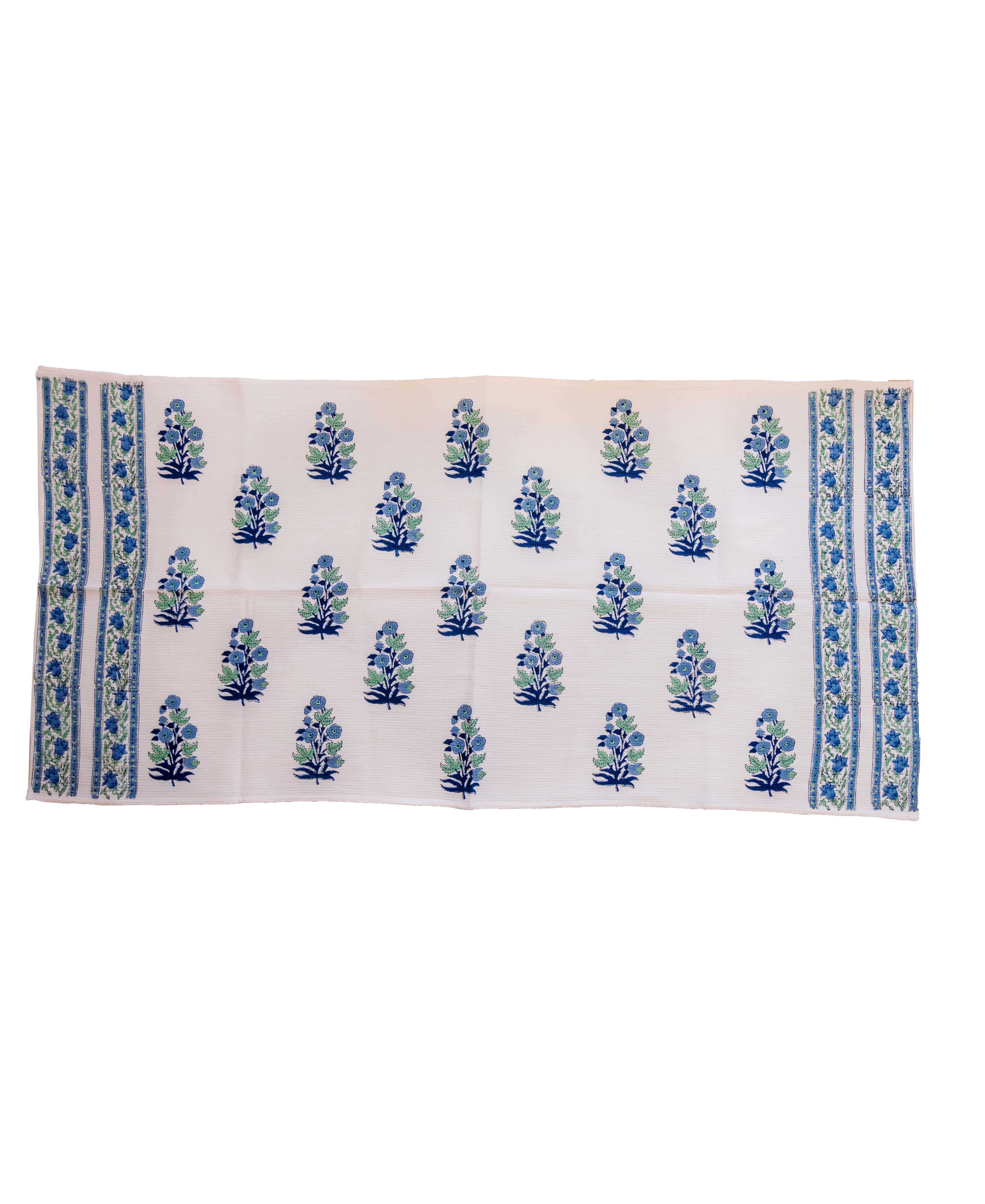 Flat lay off-white hand towel, block-printed with blue floral motifs and blue-green striped borders.