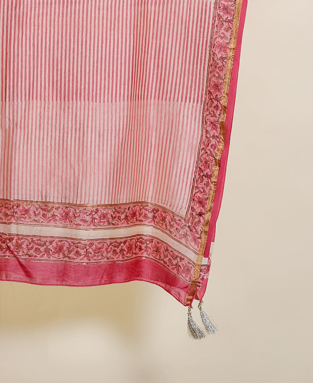 Hanging pink striped chanderi dupatta with floral border, gold trim, and silver tassels.