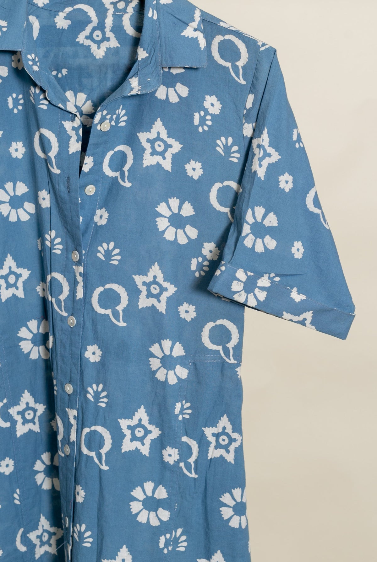 Blue handblock cotton collar-neck dress, showing white star, floral, and paisley print.