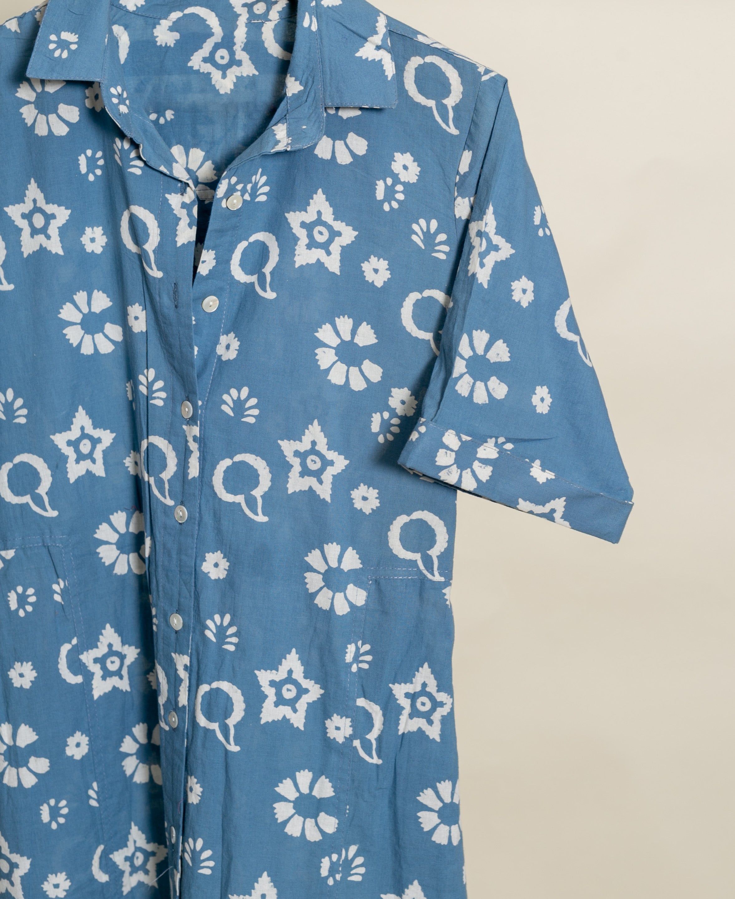Blue handblock cotton collar-neck dress, showing white star, floral, and paisley print.