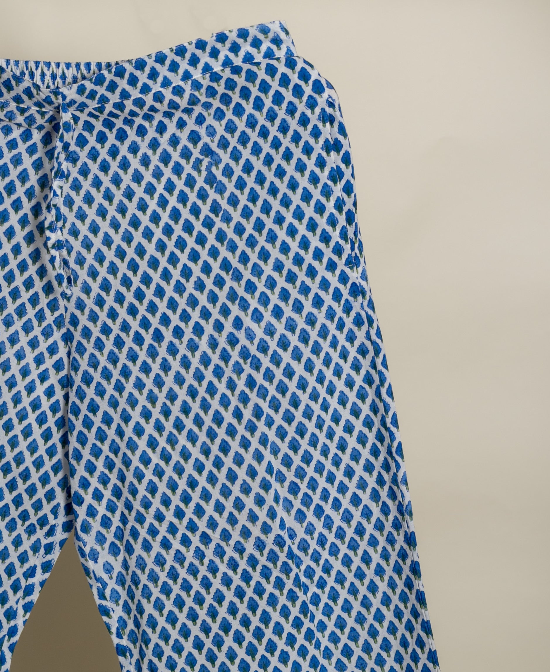 Flat-lay, cropped, blue and white block-printed cotton pants.