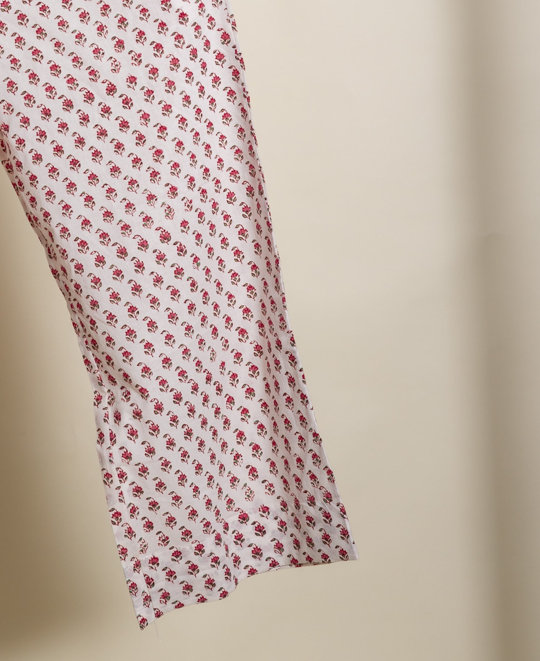A close-up of a white and pink floral print fabric, likely part of a co-ord set.