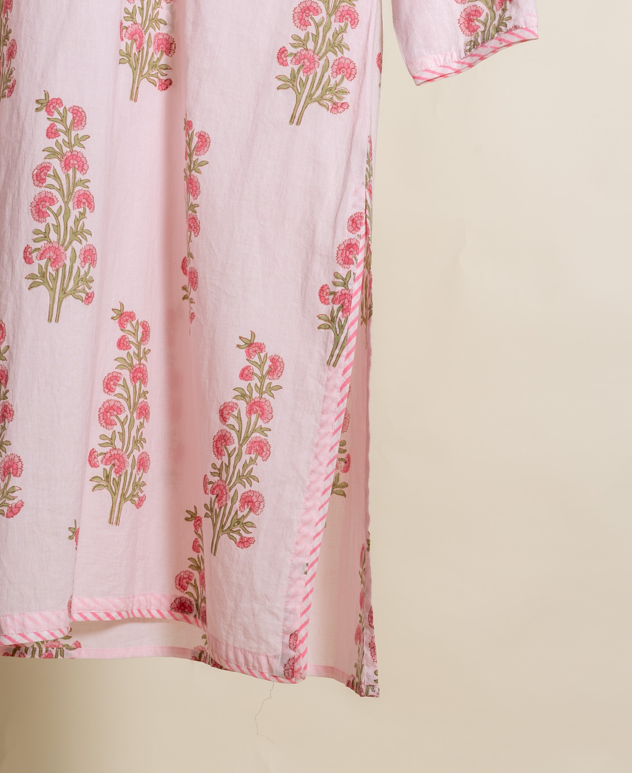 Baby pink floral handblock cotton ethnic kurti with striped side slit and sleeve.