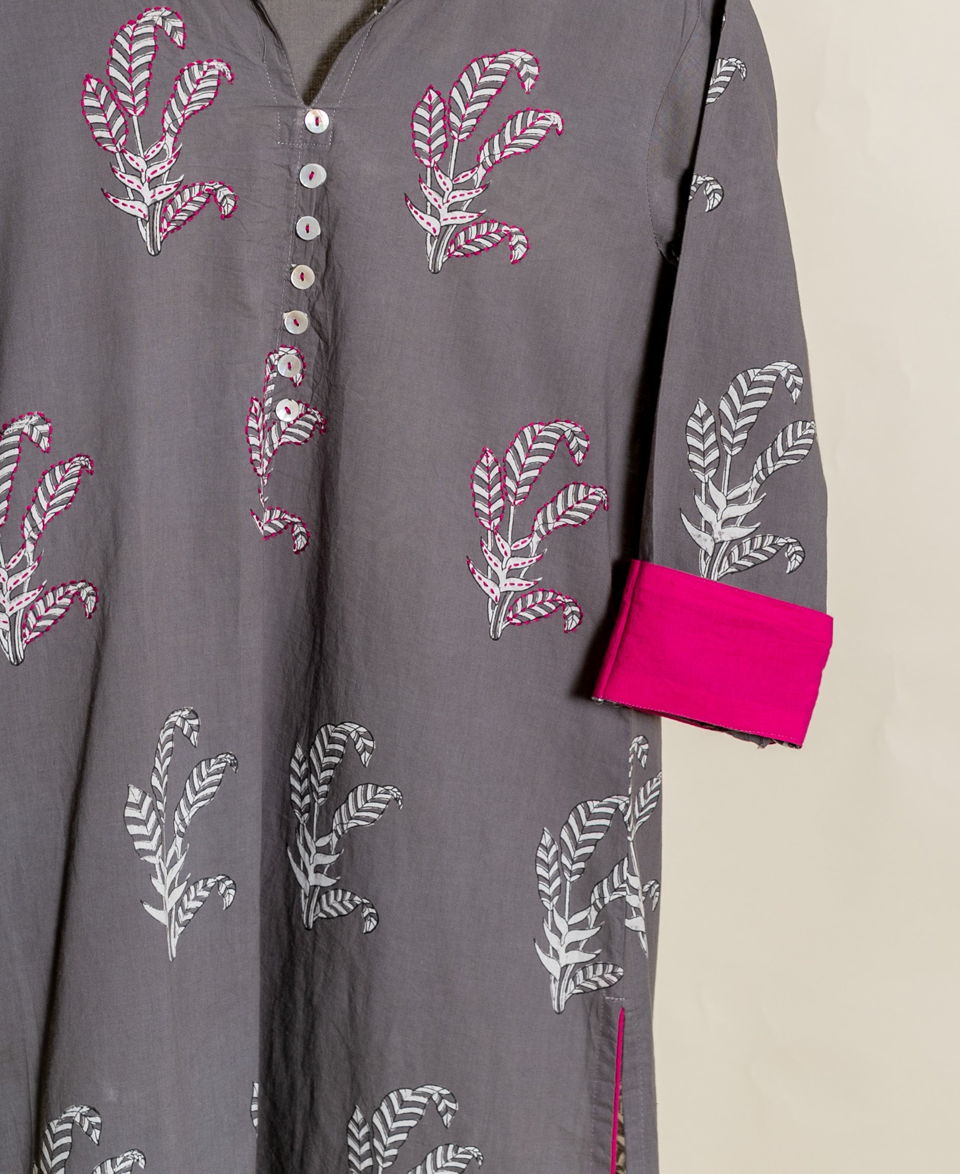Grey hand block printed cotton cord set with pink accents and white buttons.