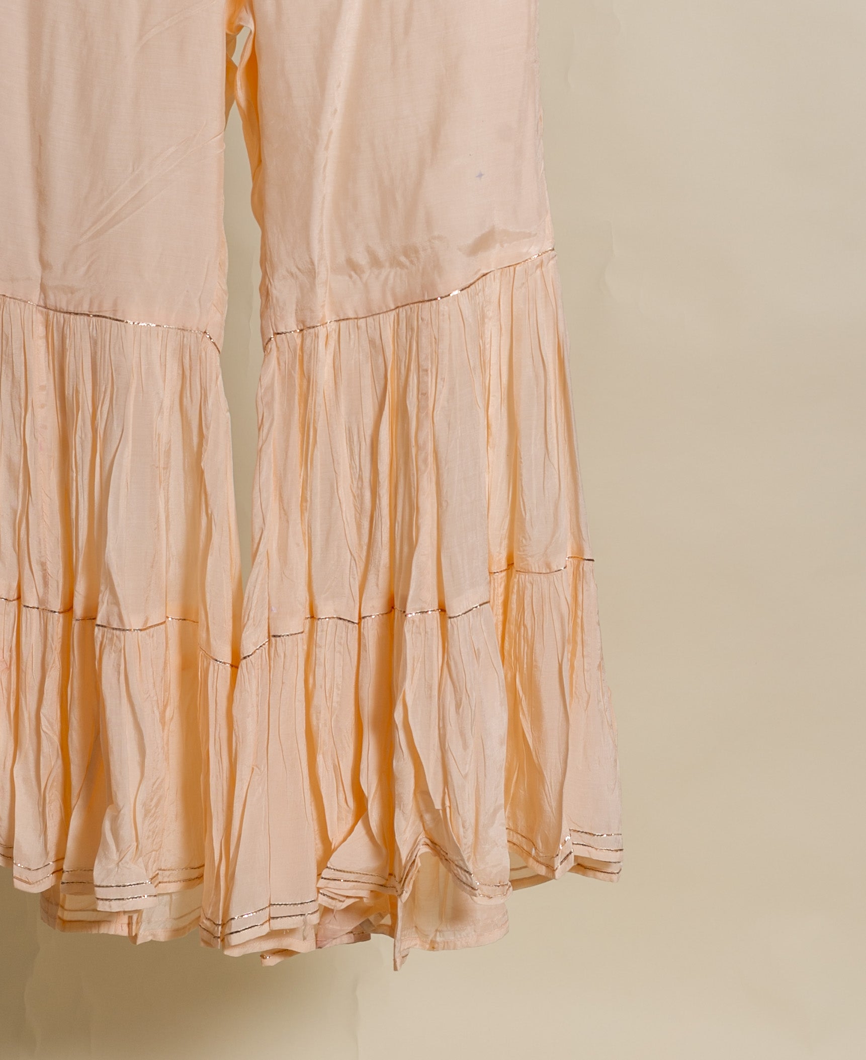 A peach silk chanderi kurta with muslin sharara and chanderi dupatta.