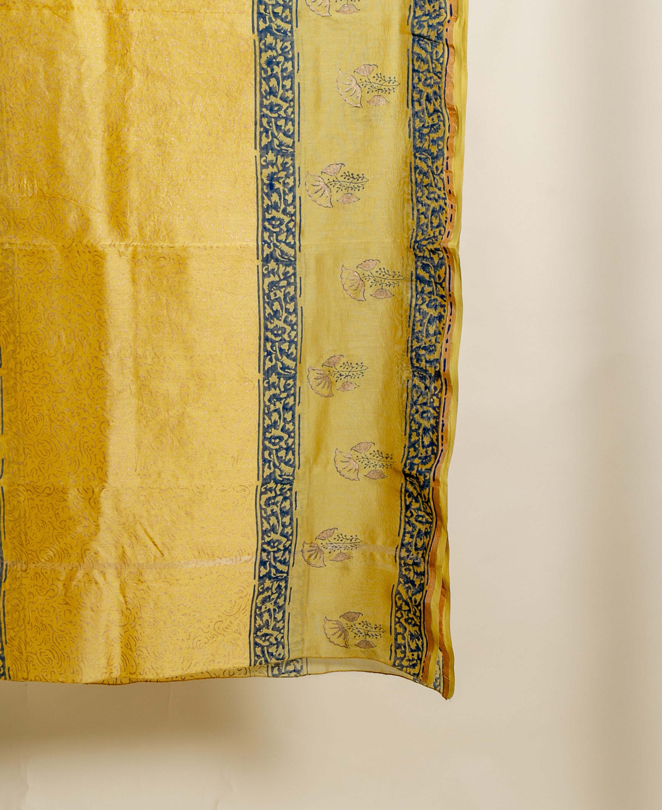 Hanging mustard chanderi dupatta with indigo leafy and subtle pink floral block prints.
