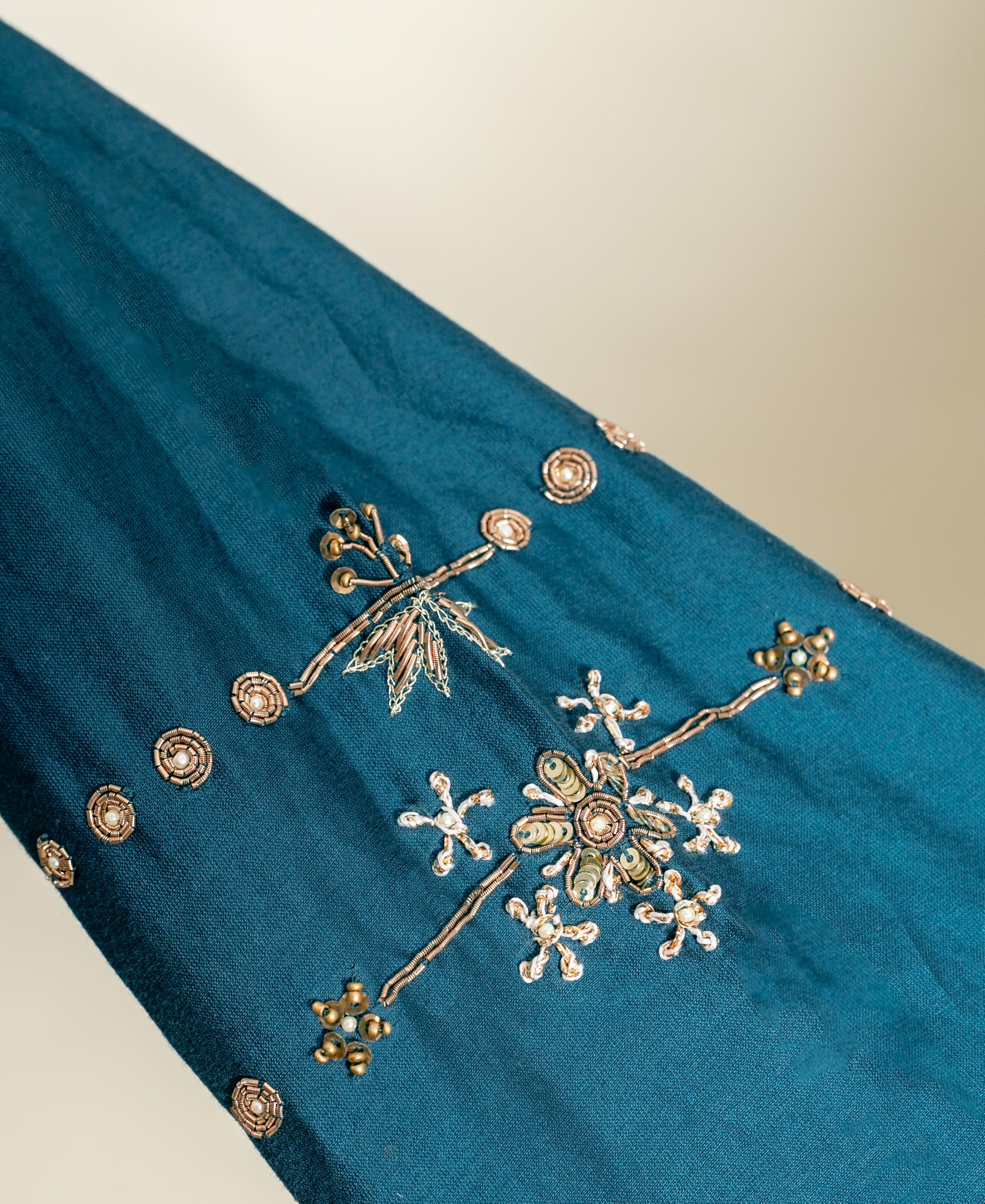 Teal silk kurta with gold embroidery and floral pattern.