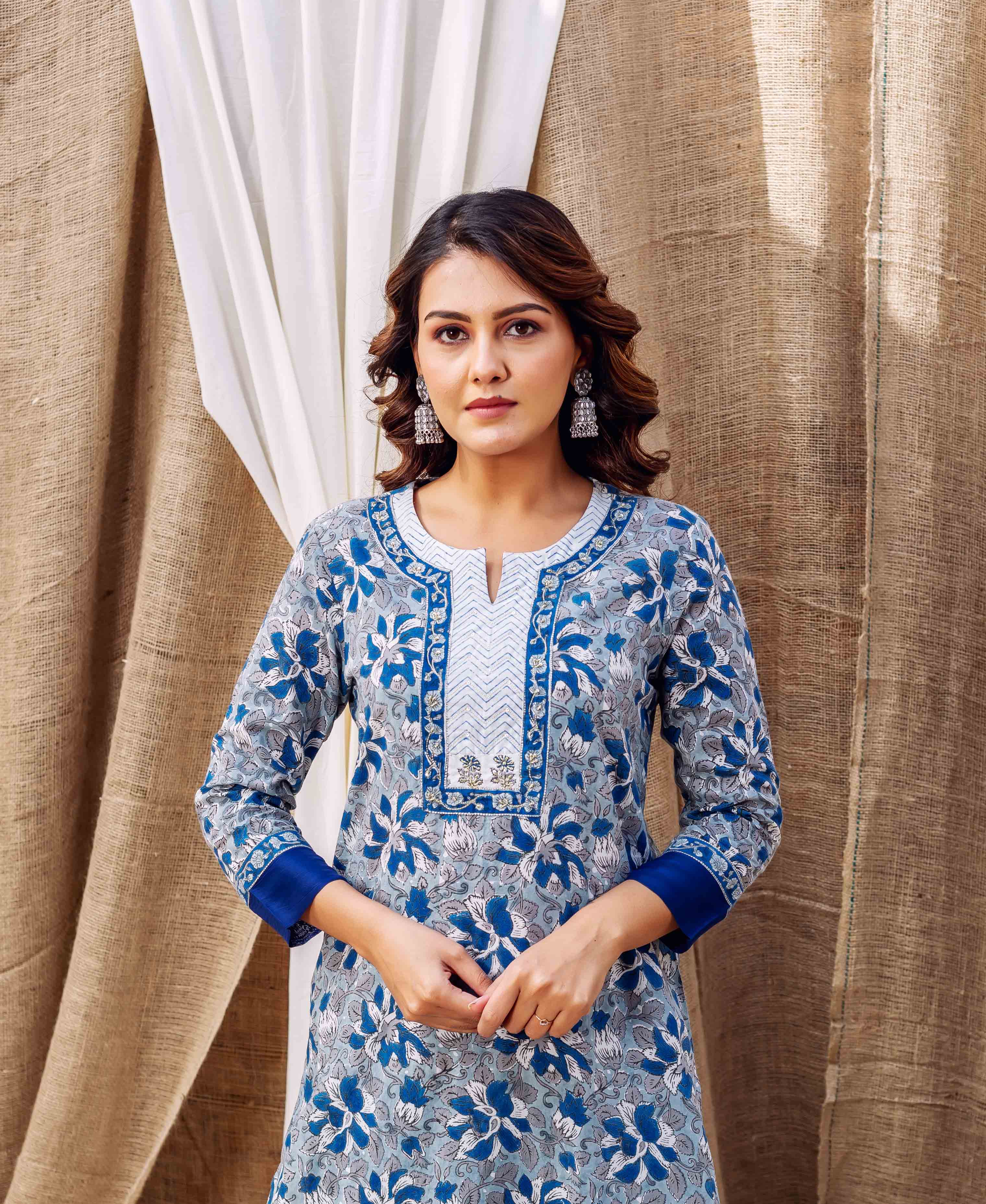 Front view model wearing grey and blue floral hand-block print kurta with white yoke.