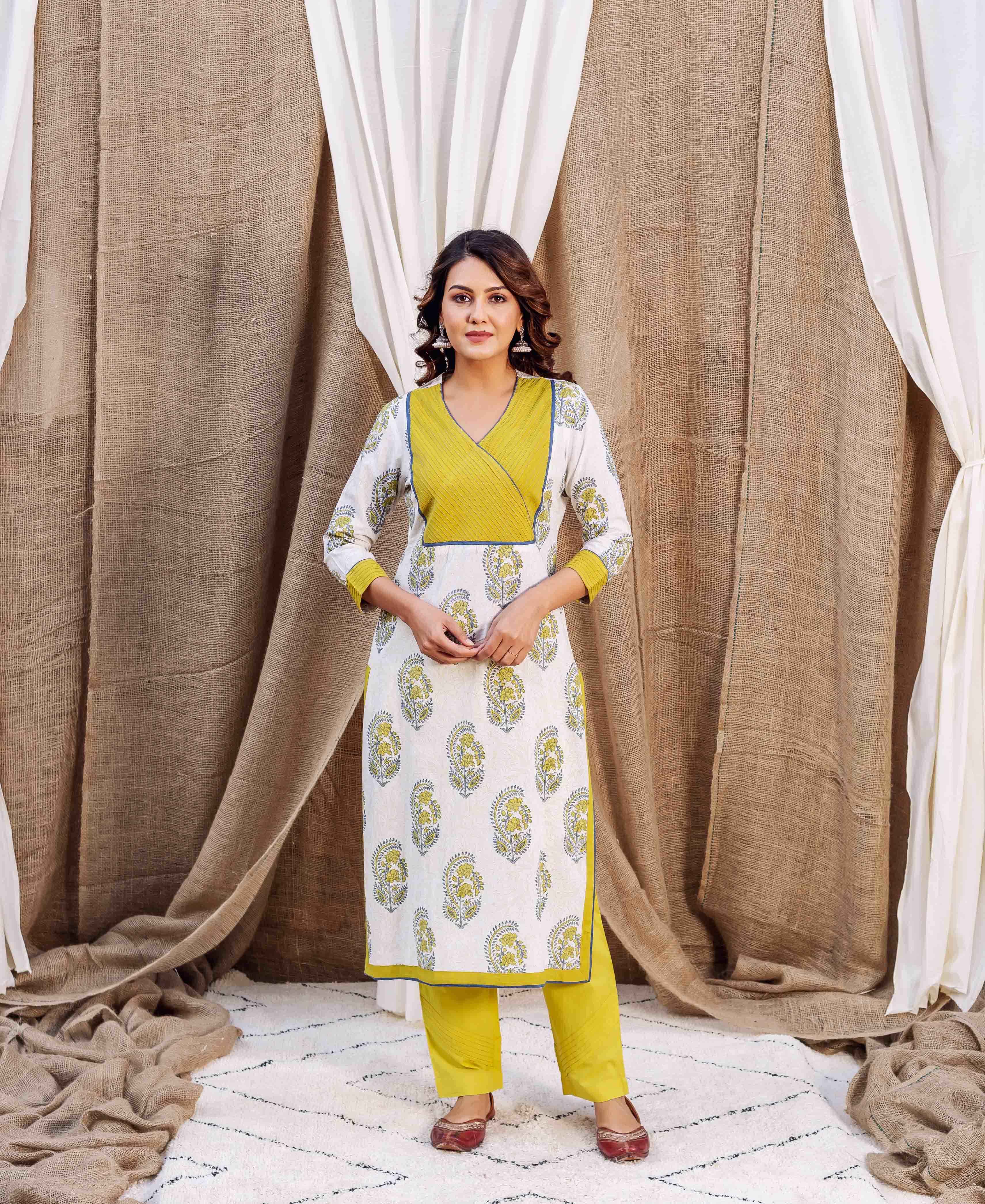 Full shot of model wearing white block-printed straight kurta with yellow yoke and matching yellow pants.