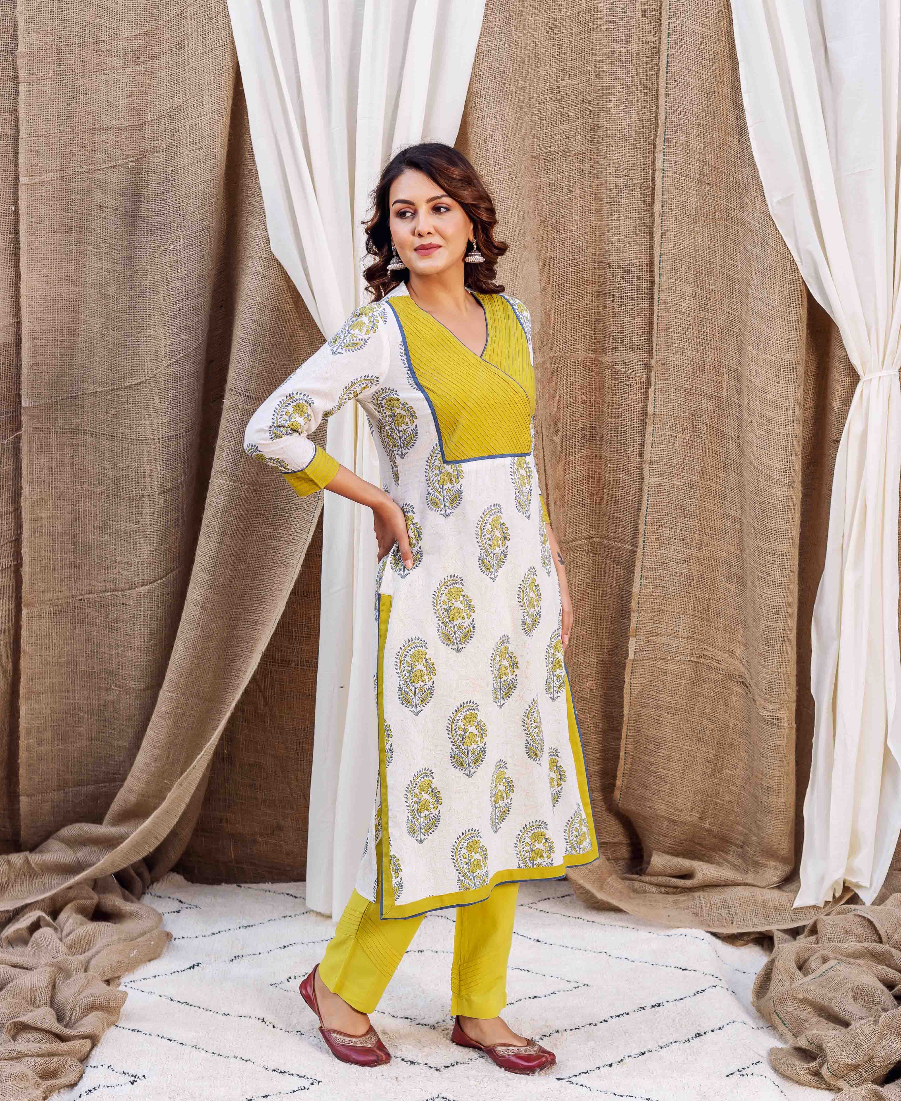Model wears white floral block printed straight kurta with yellow wrap V-neck.