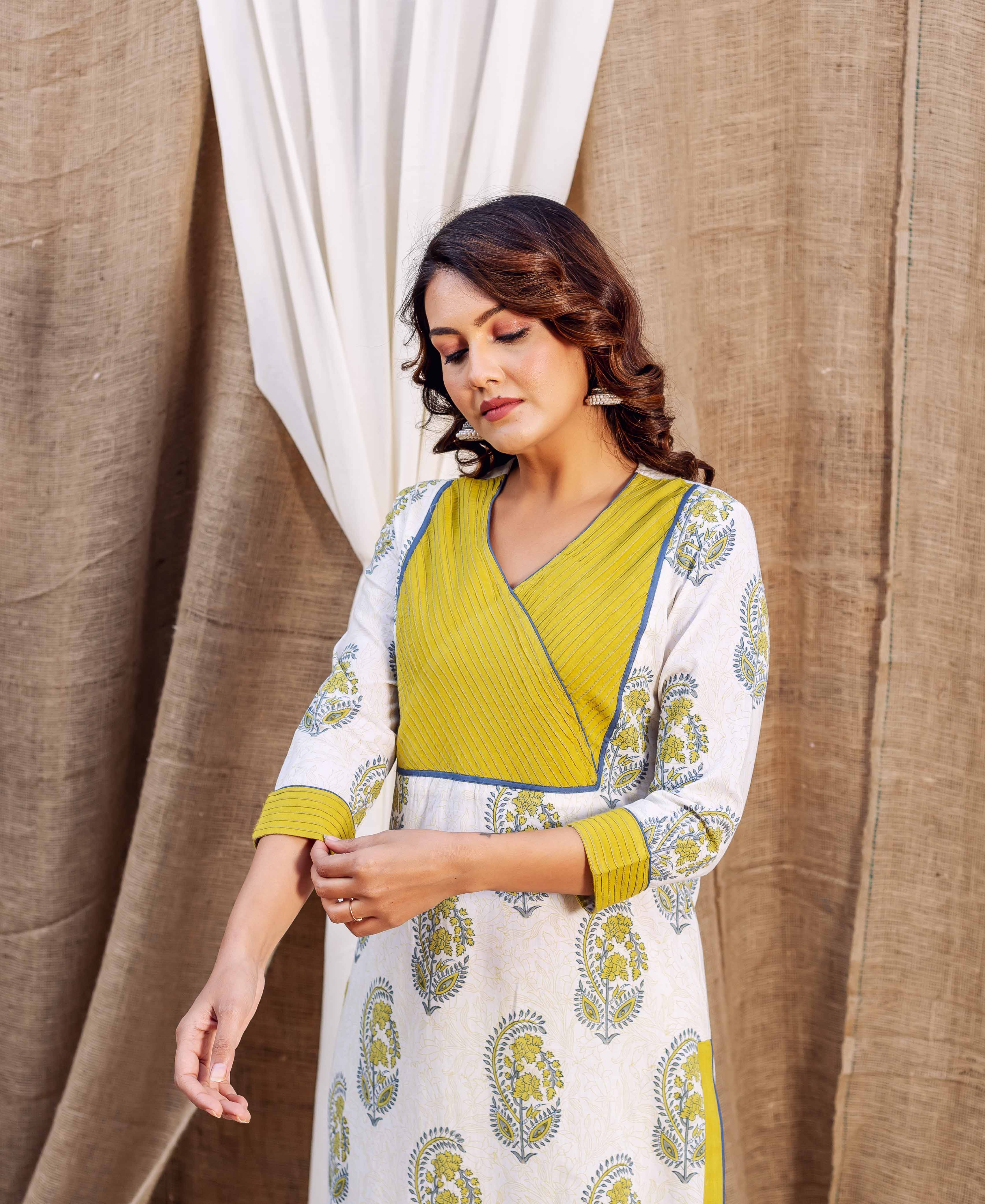 Woman in an off-white floral block printed straight kurta with olive green angrakha yoke.