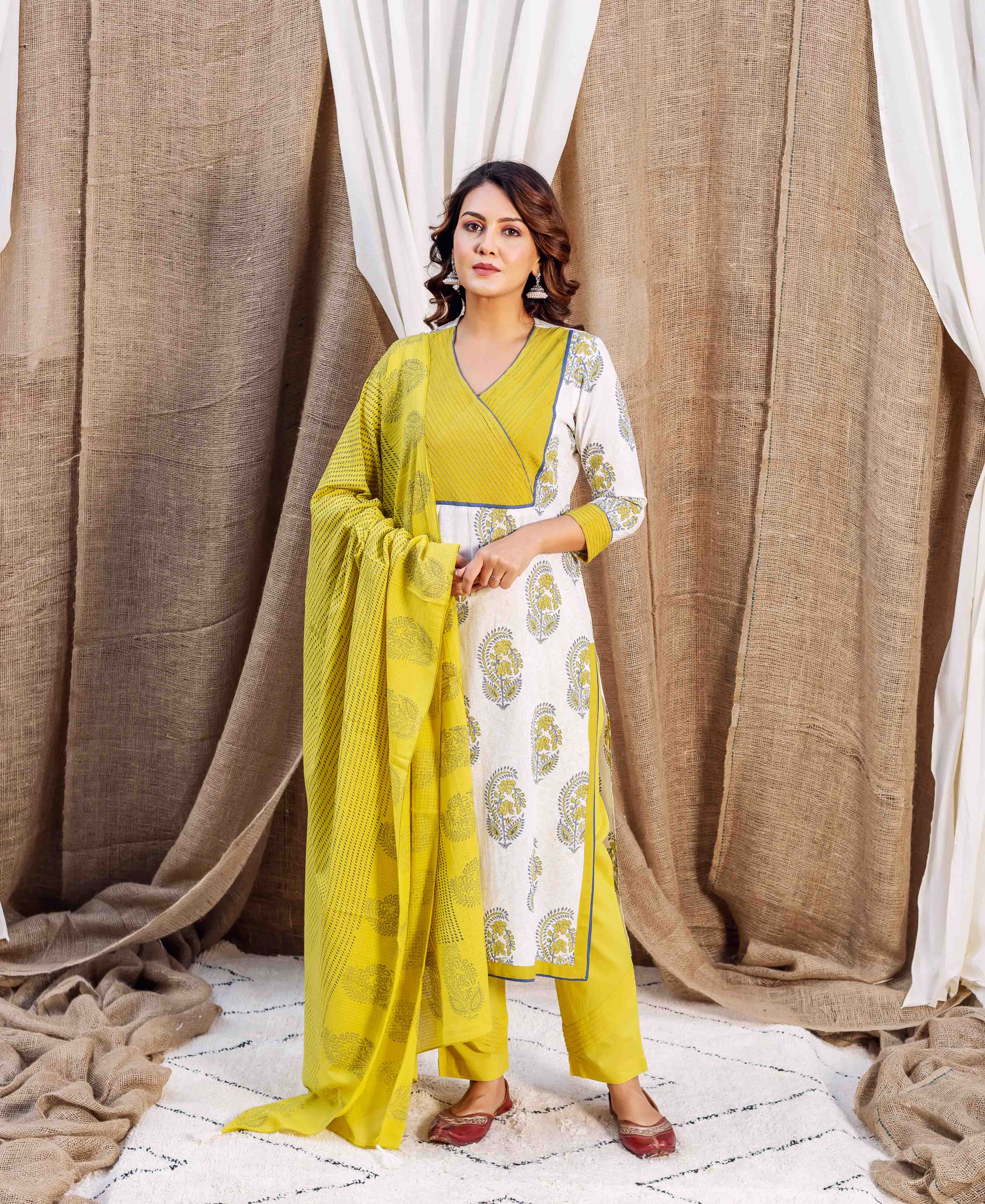 Model in a cream and yellow block printed straight kurta set with matching dupatta.