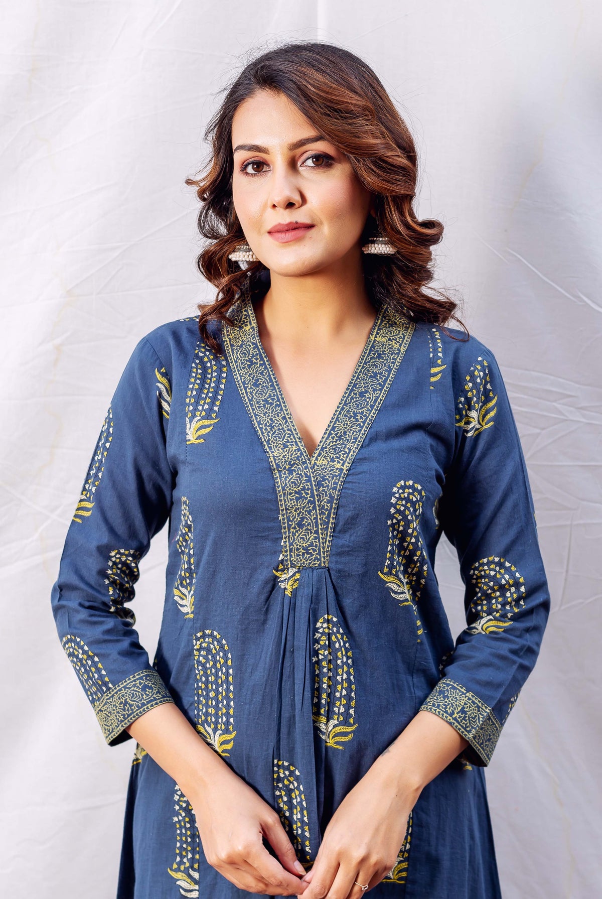 Front view of model wearing an indigo and ochre block printed A-line kurta.