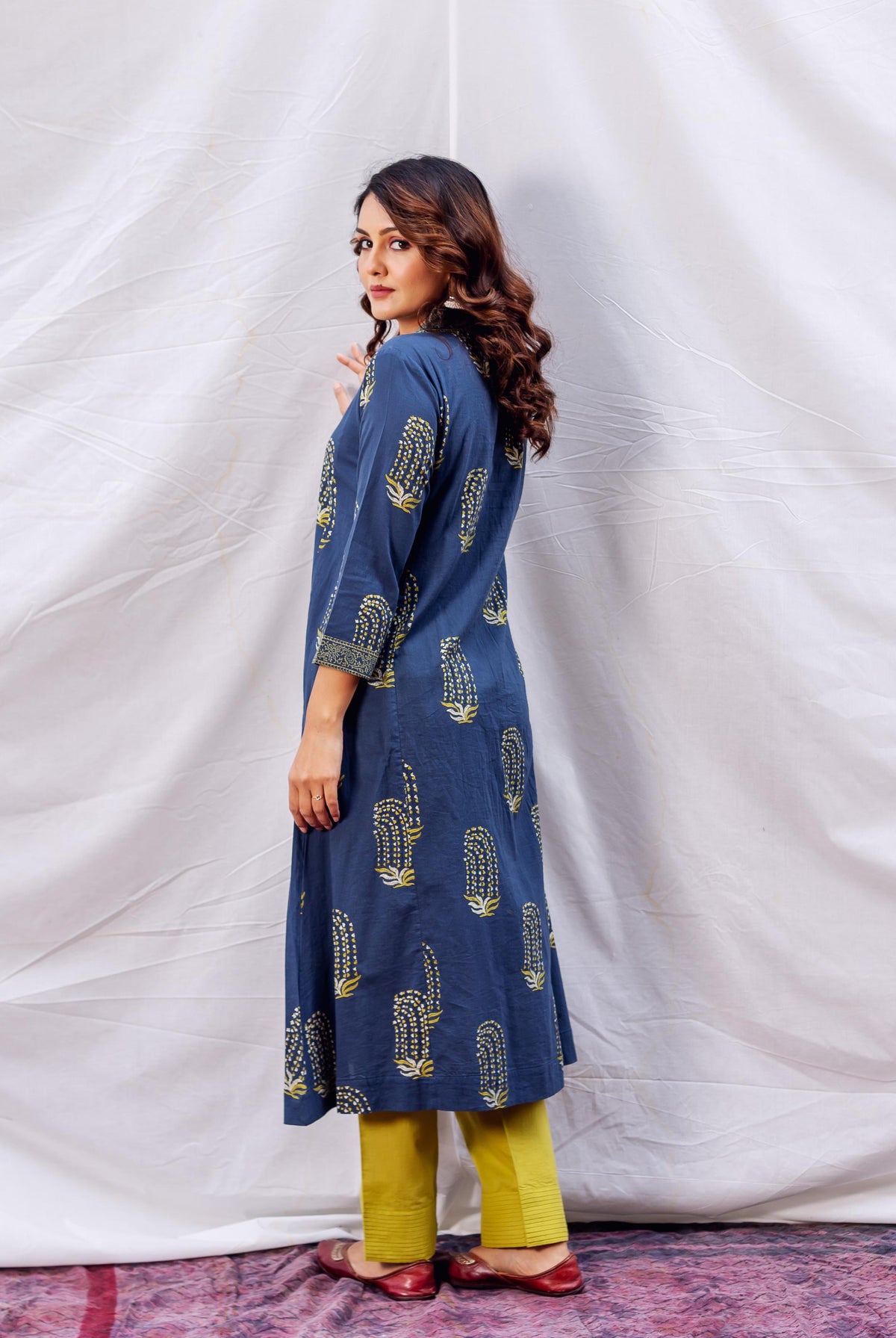 Model wears full look, side view, indigo and ochre block printed A-line kurta.