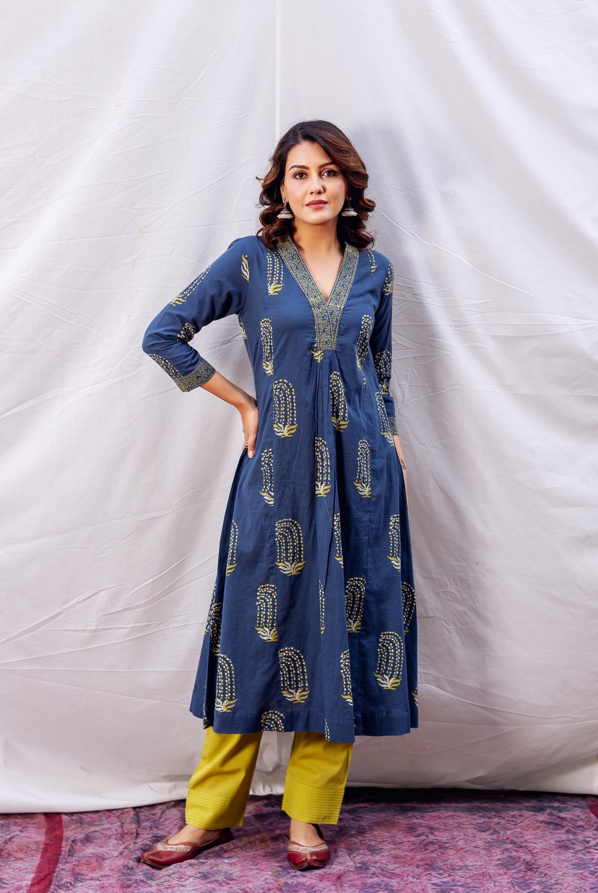 Front view model wearing indigo ochre block printed A-line kurta with yellow pants.