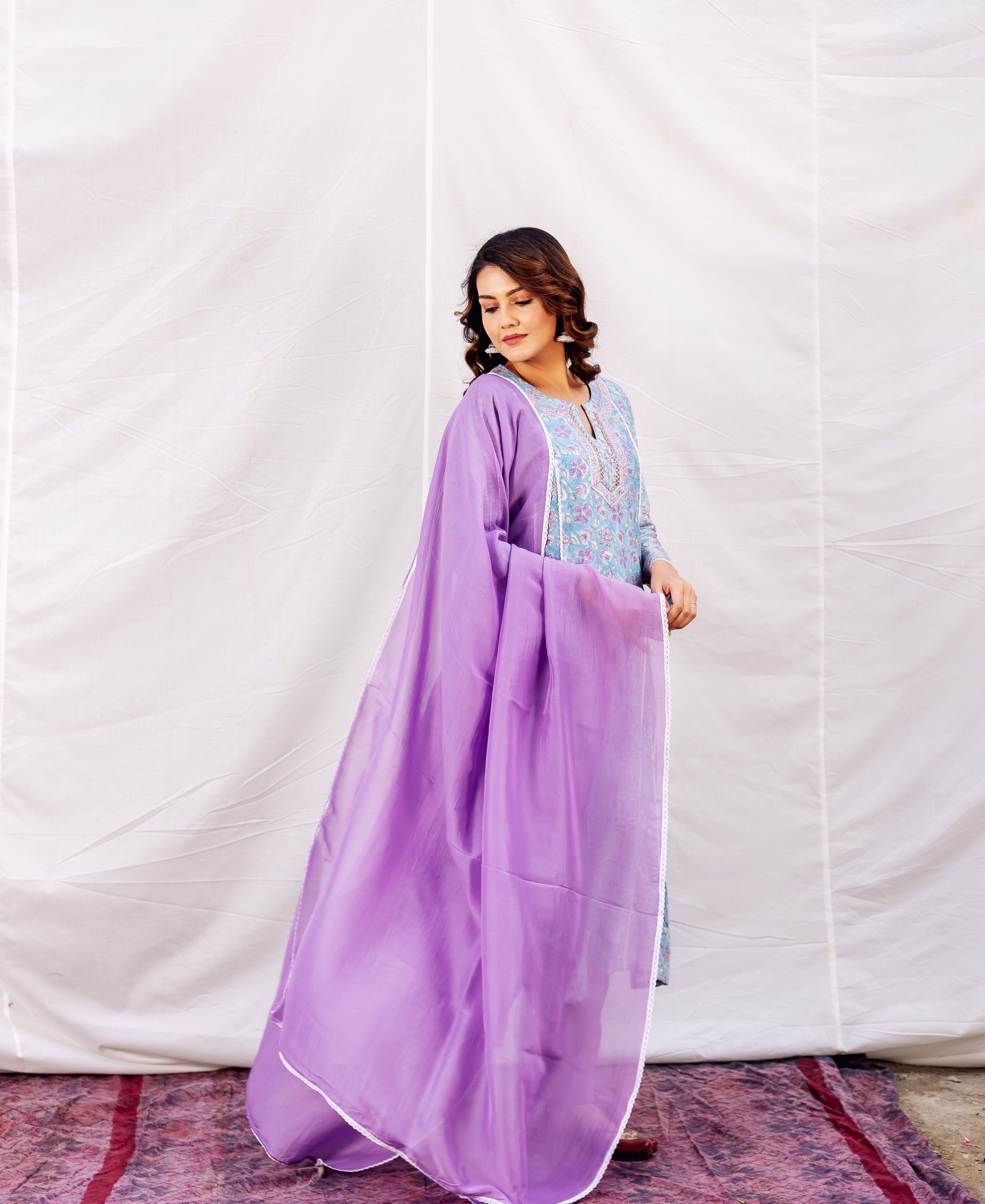 Woman in light blue hand-block-printed Chanderi embroidered kurta with purple dupatta.