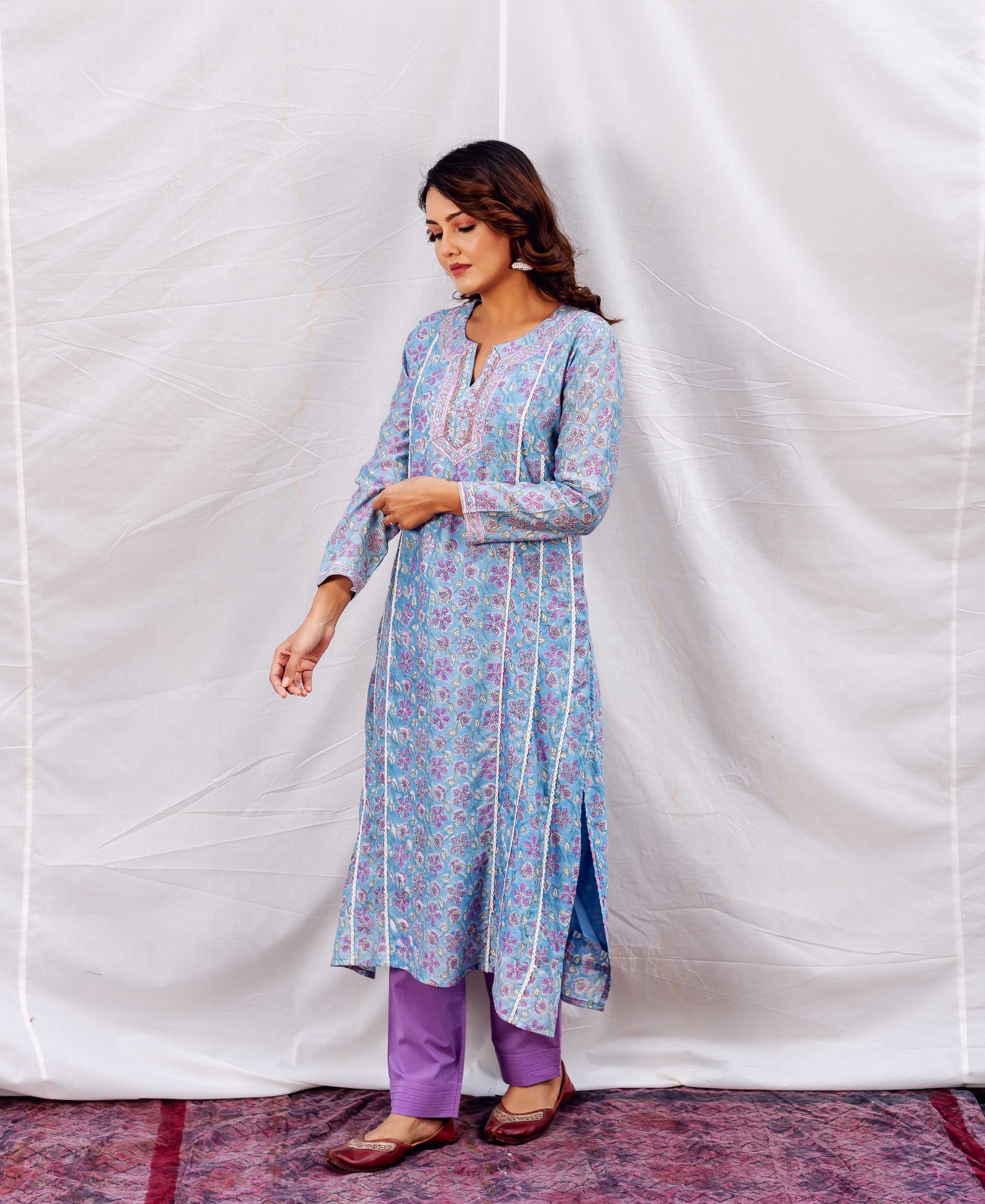 Full-length model in light blue floral hand-block printed kurta with embroidered neckline and white stripes.