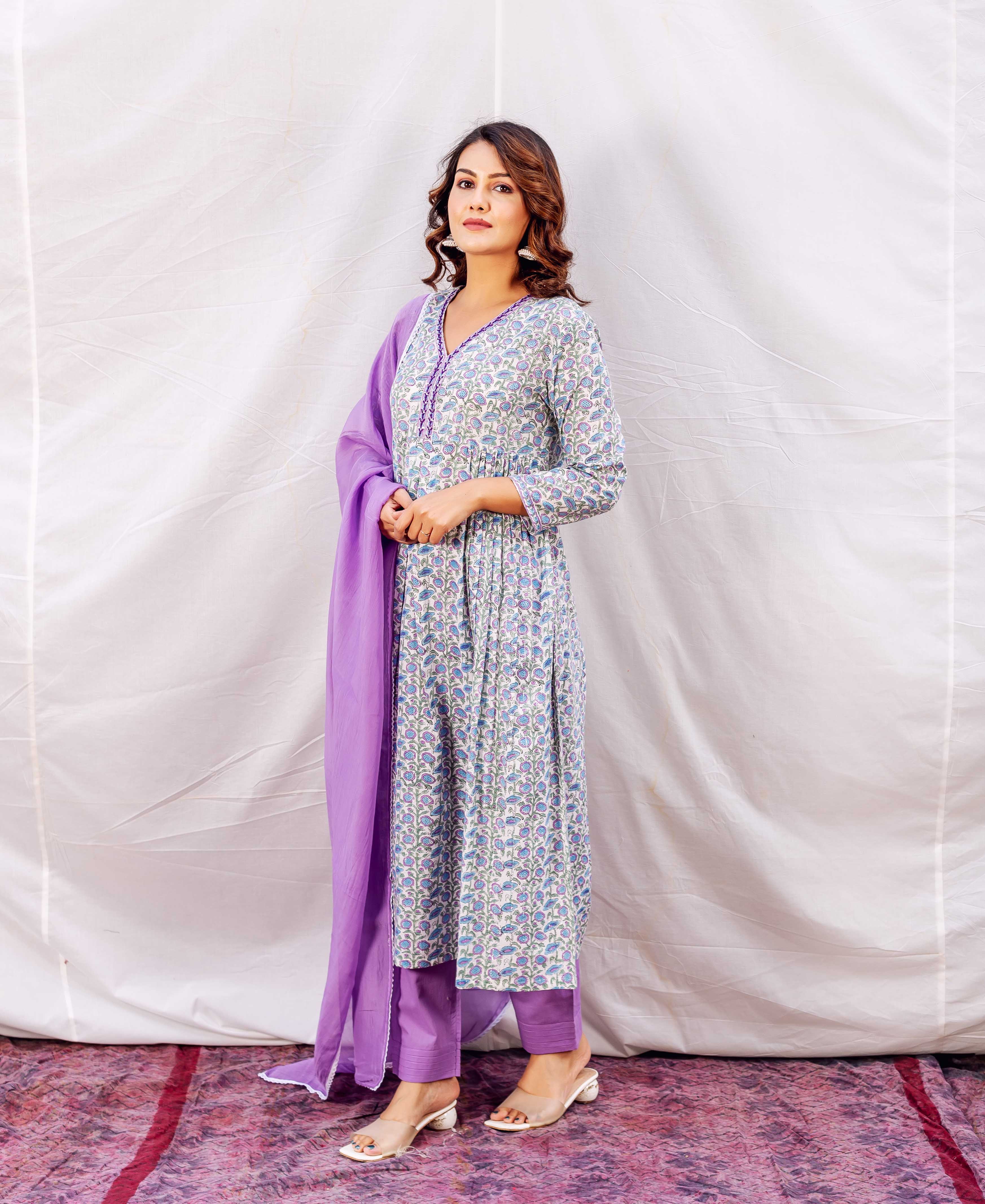 Model wears a light blue and purple floral print A-line kurta set.