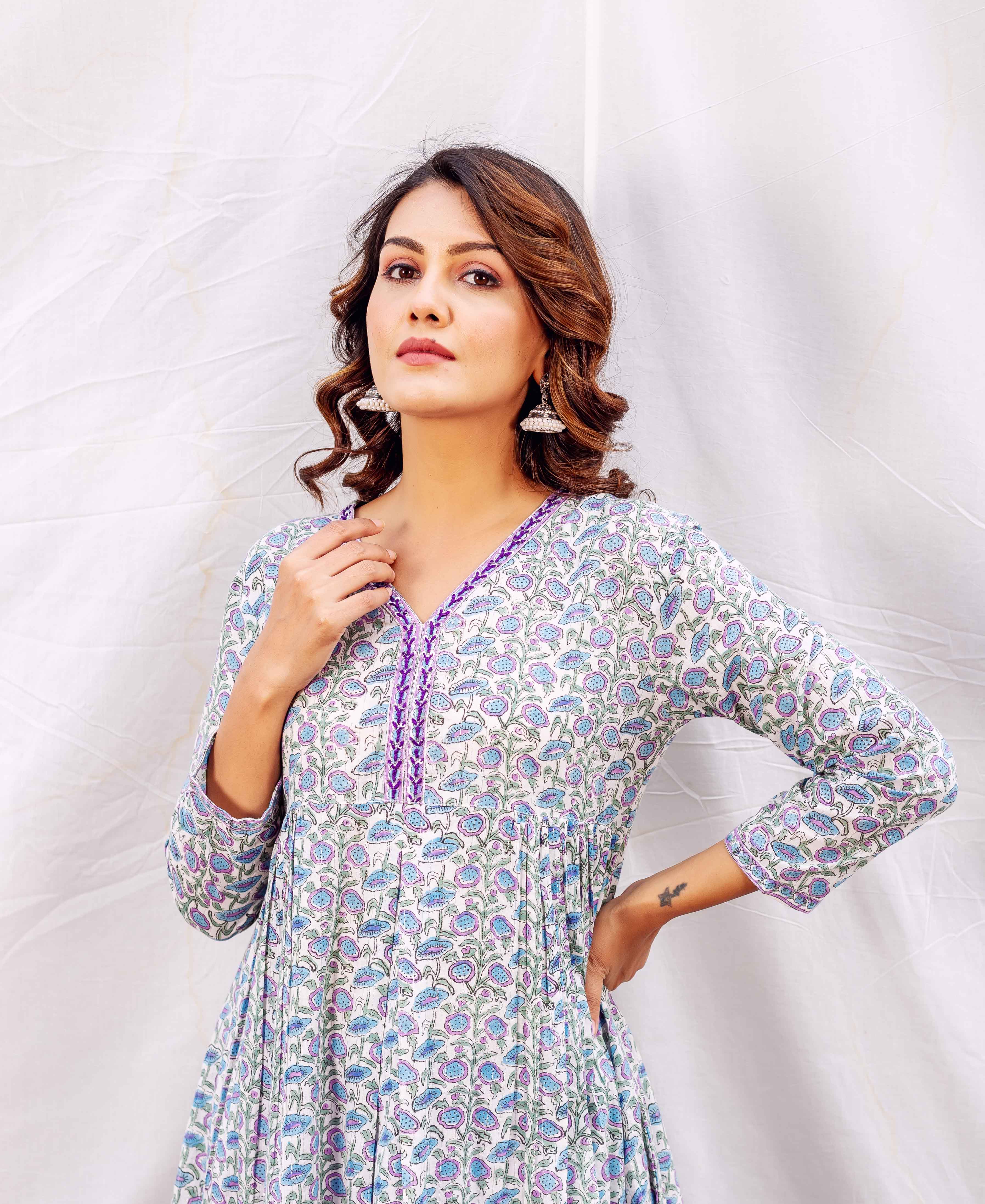Model in white, blue, purple floral block print A-line kurta with purple V-neck.