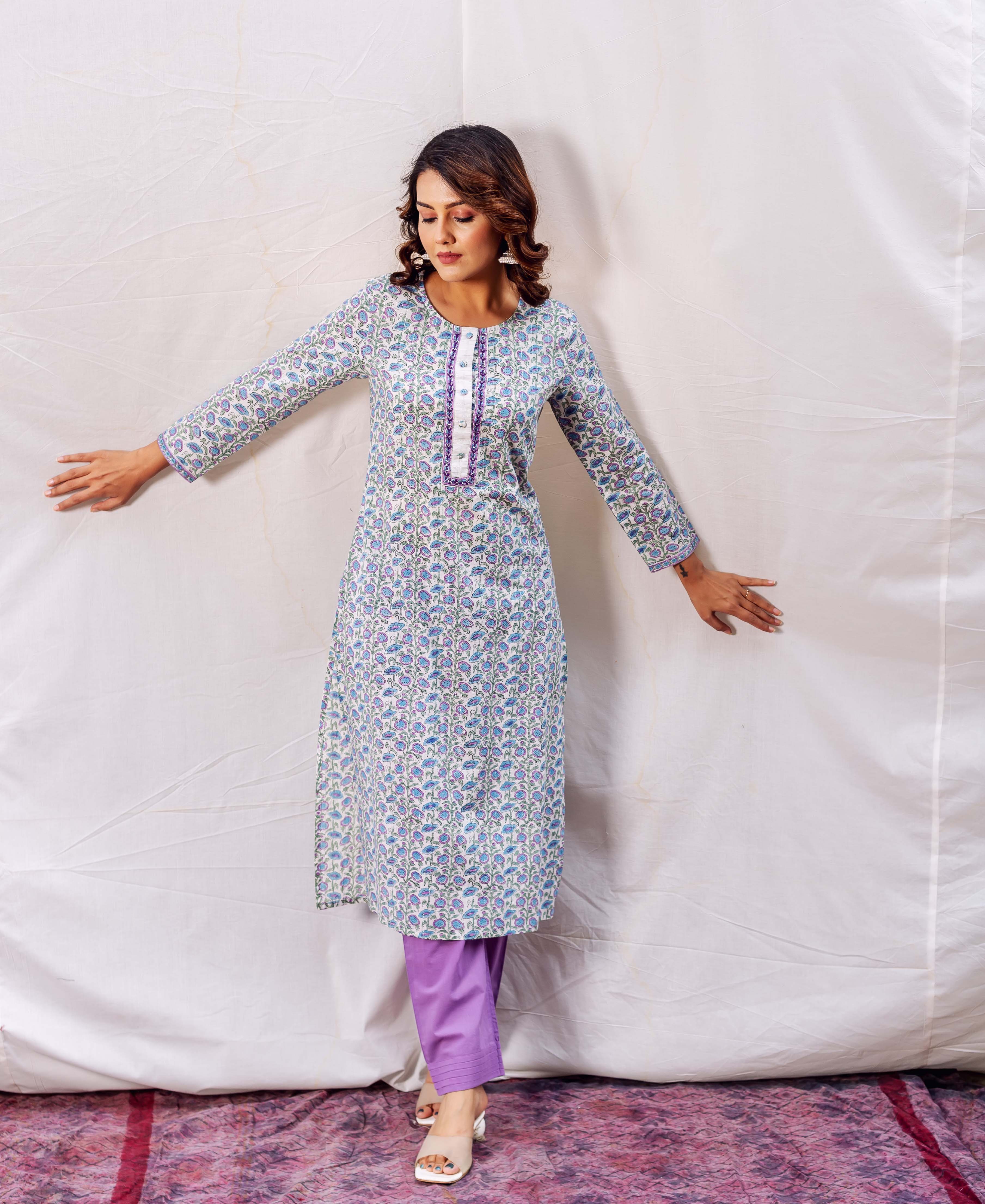 Model wears a blue and purple floral hand-block printed straight kurta with purple pants.
