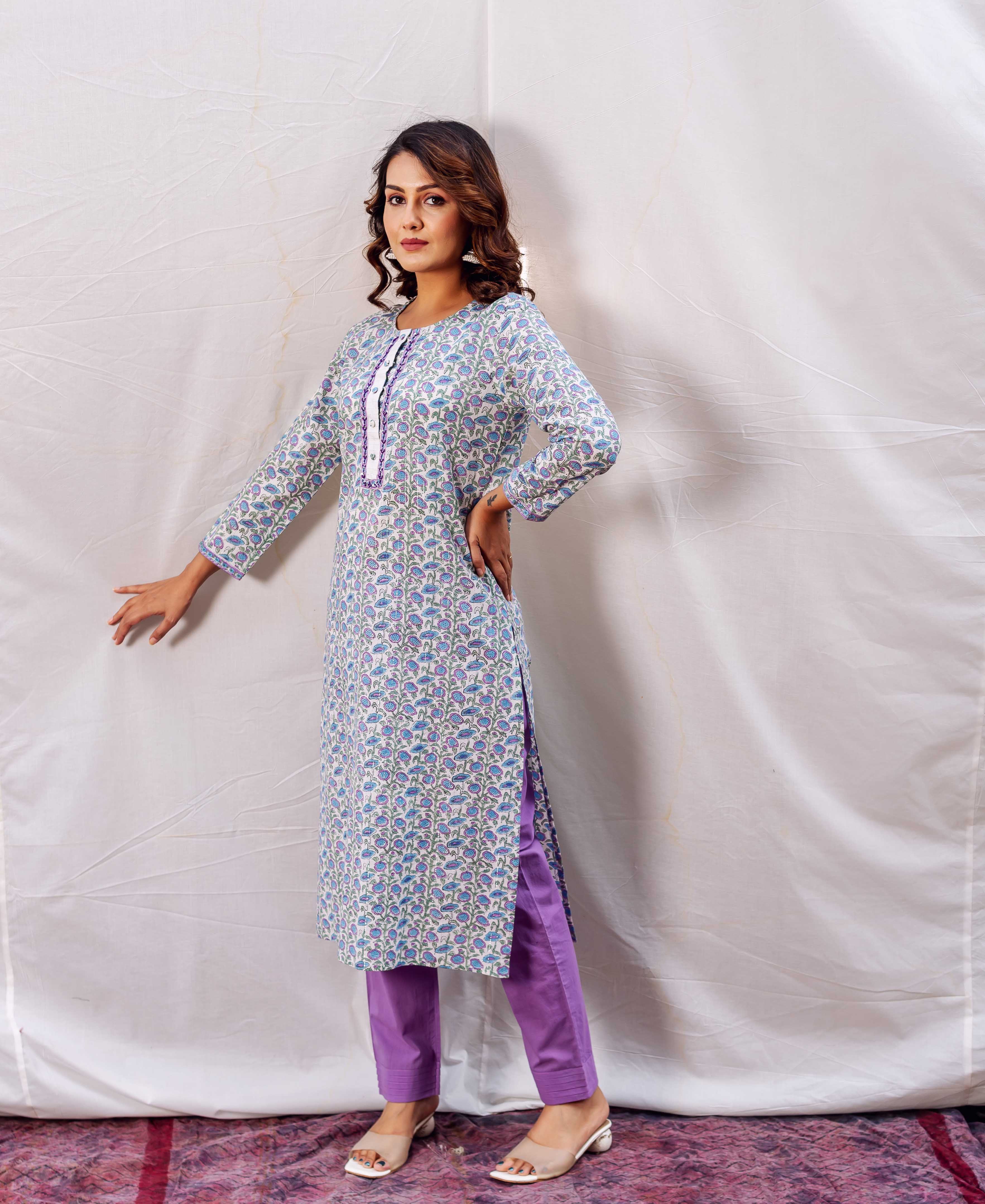 Model wears light blue floral hand-block-printed straight kurta with solid purple pants.