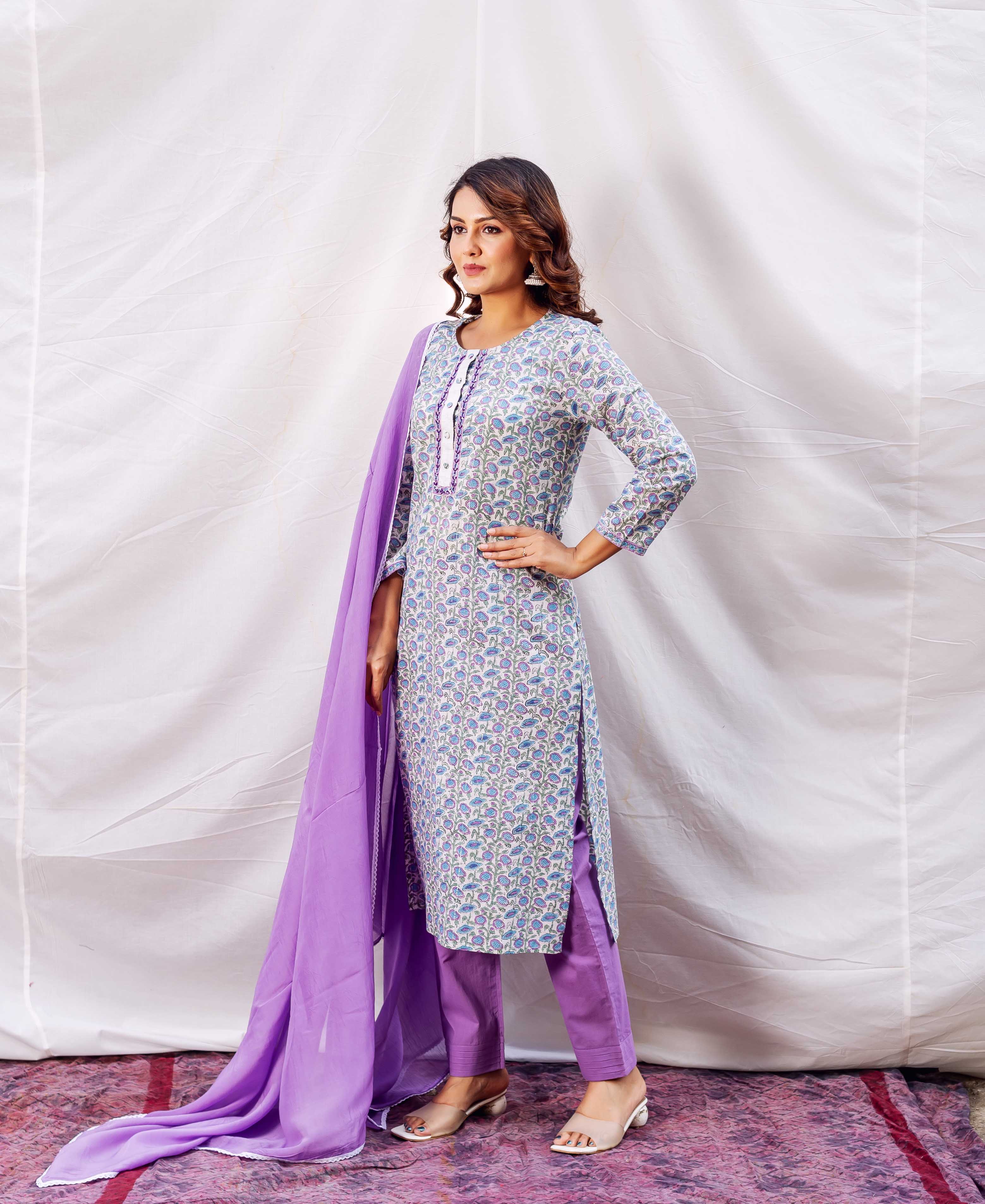 Model in light blue and lavender floral block-printed kurta set with purple dupatta.