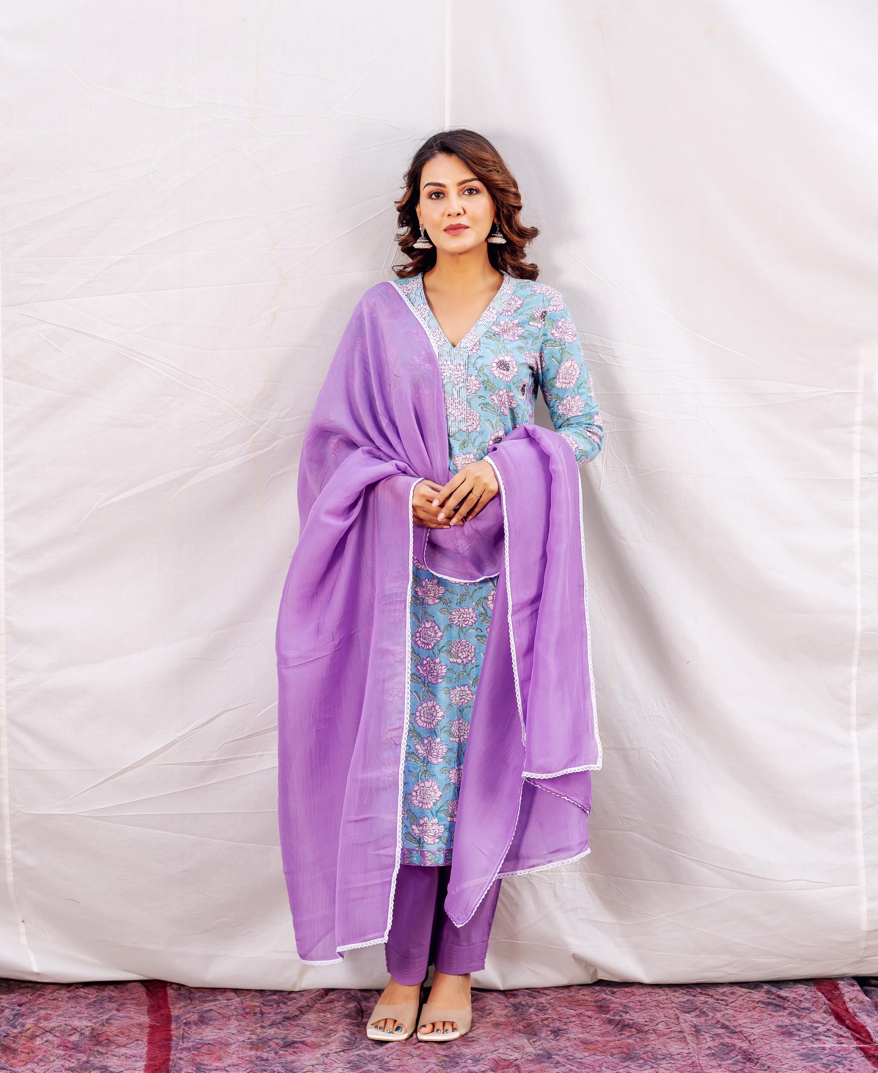 Model in light blue hand-block-printed kurta with pink florals and lilac embroidered dupatta.