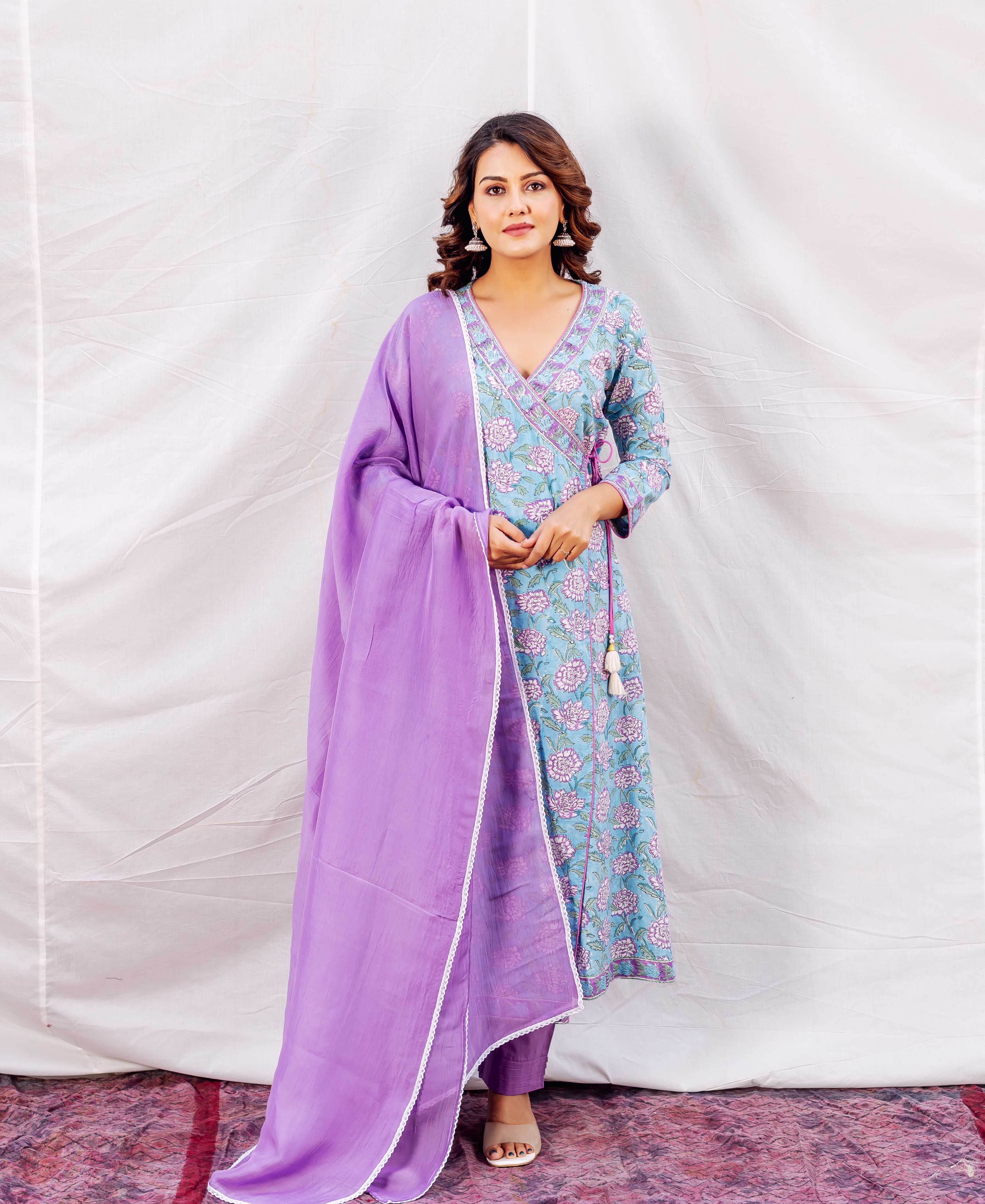 Full-length model in a light blue floral hand-block printed kurta with a solid purple dupatta.