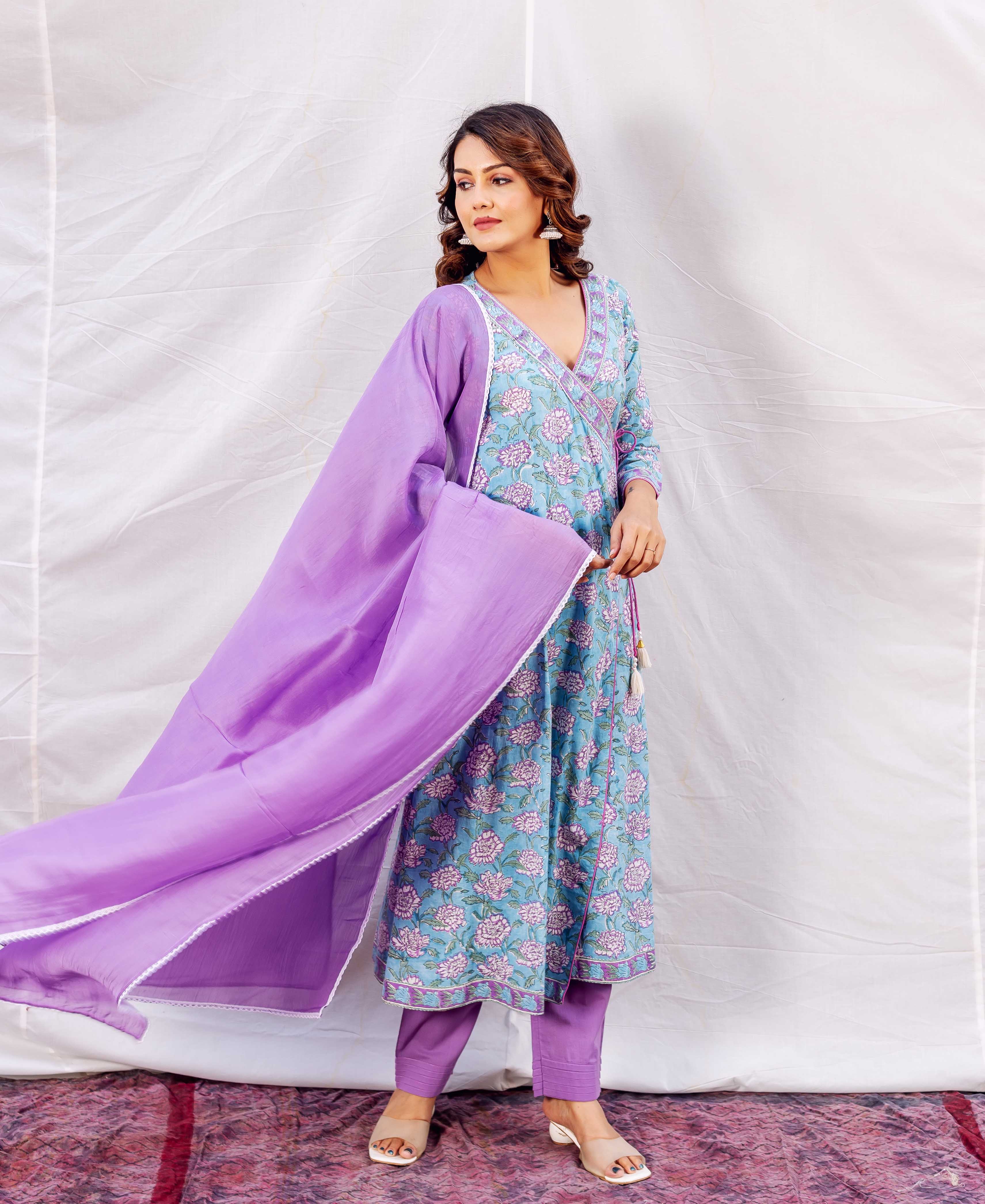 Model in light blue Angrakha kurta with pink floral print, purple dupatta and pants.