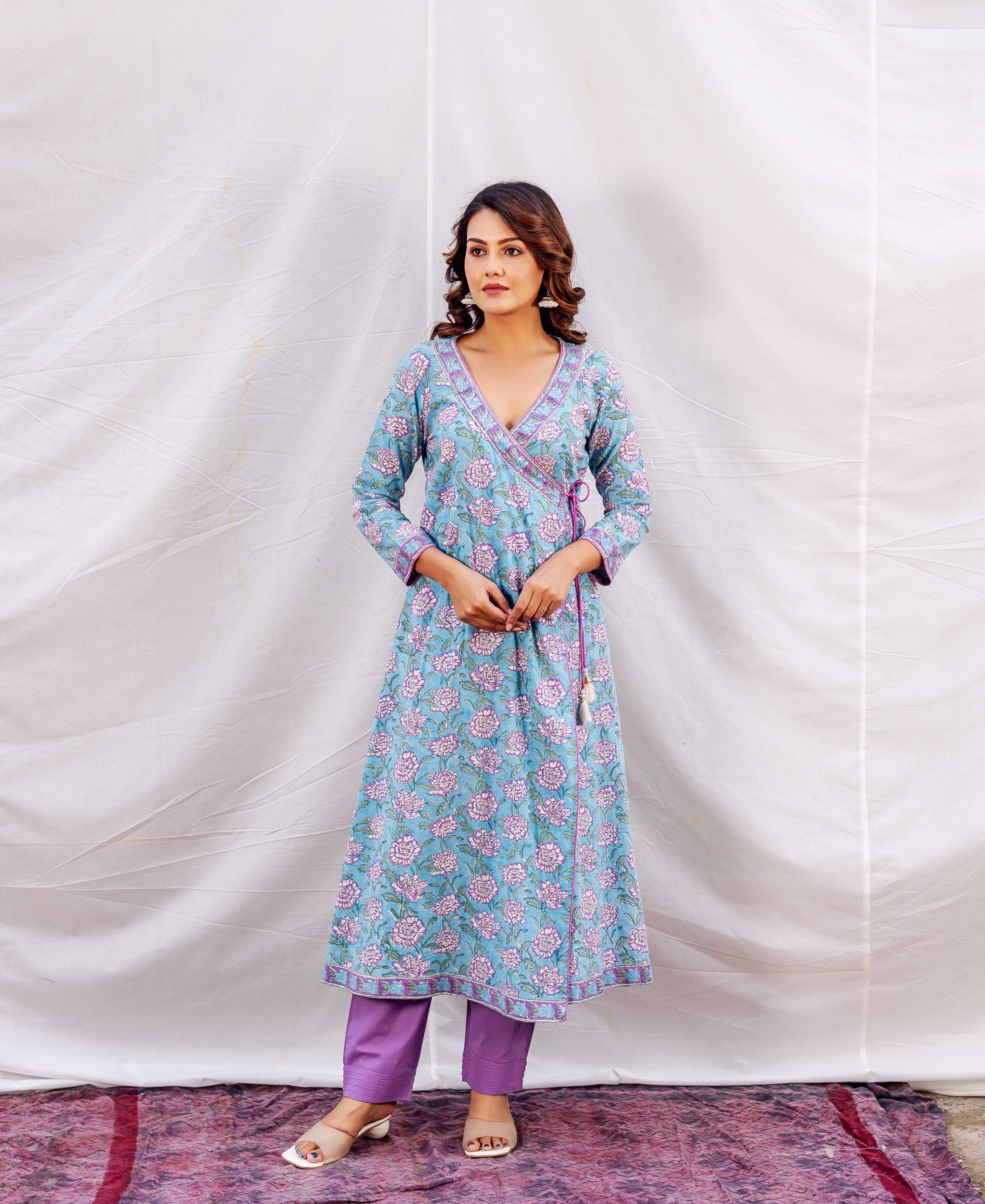 Standing model in a light blue floral hand-block-printed Pakeeza Angrakha kurta with purple accents.