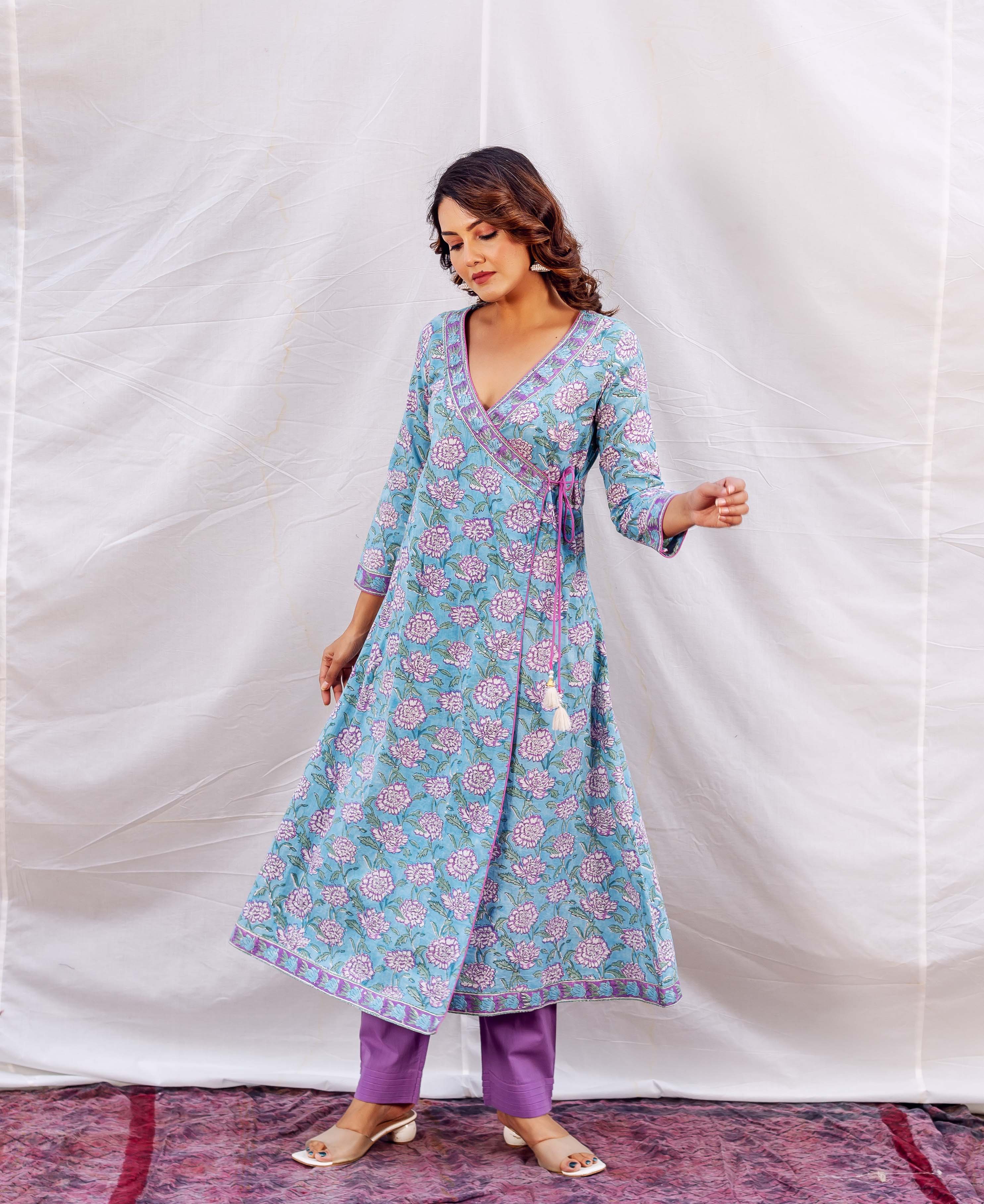 Full shot of model in a light blue floral hand-block printed Angrakha kurta and purple pants.