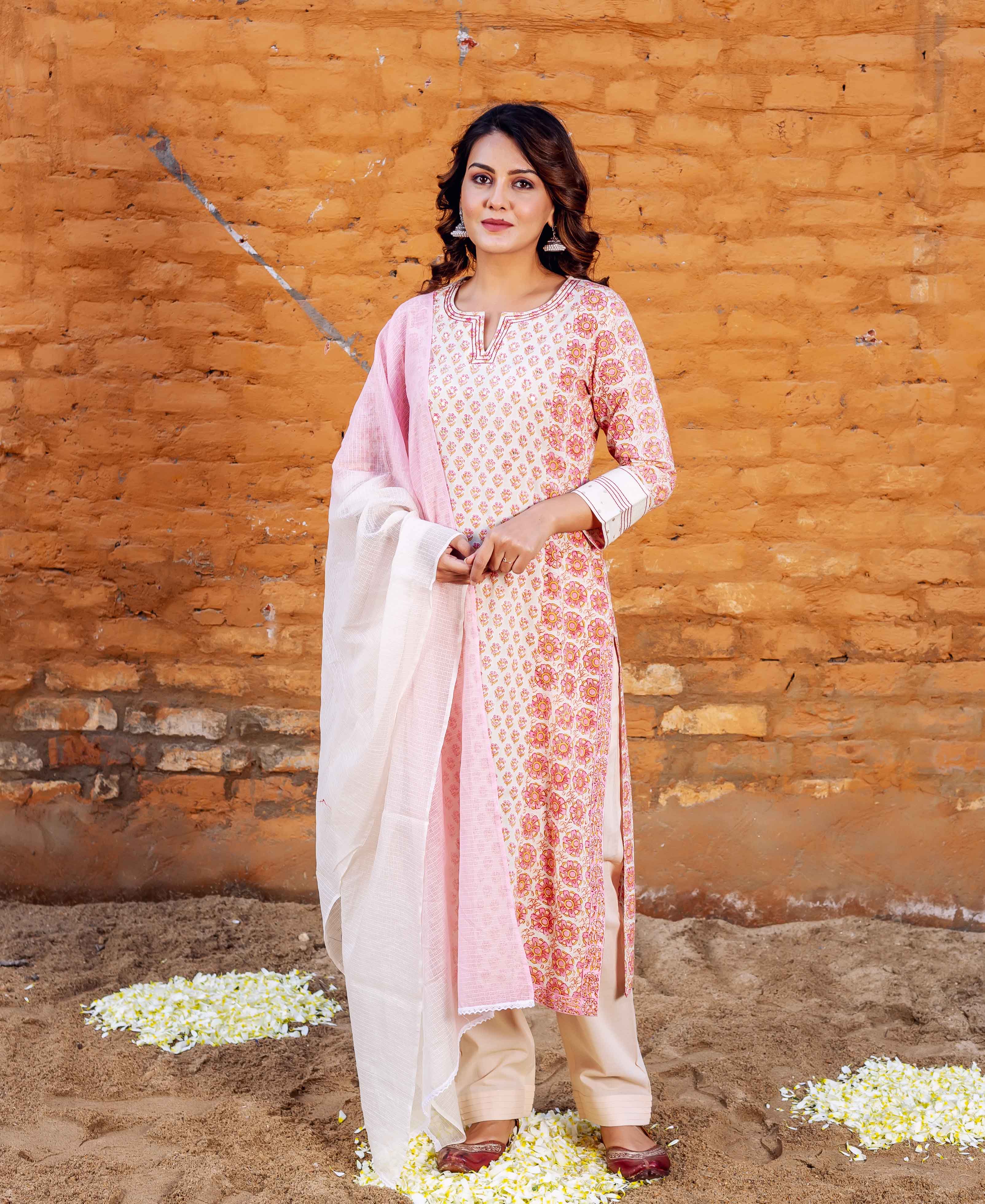 Woman wears a cream Zoya straight kurta with pink and orange floral block print.