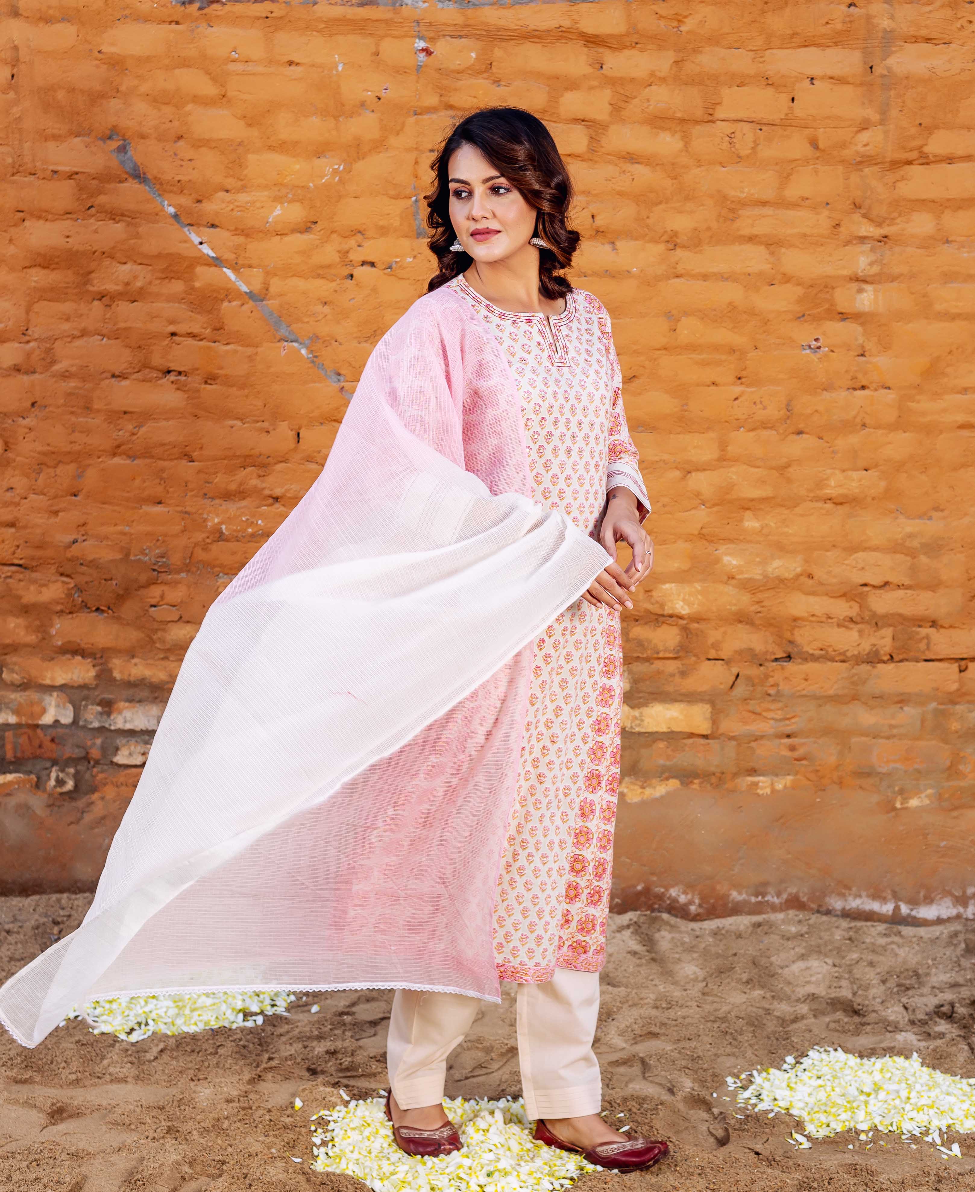 Model in a light pink and cream block-printed straight kurta with a flowing dupatta.