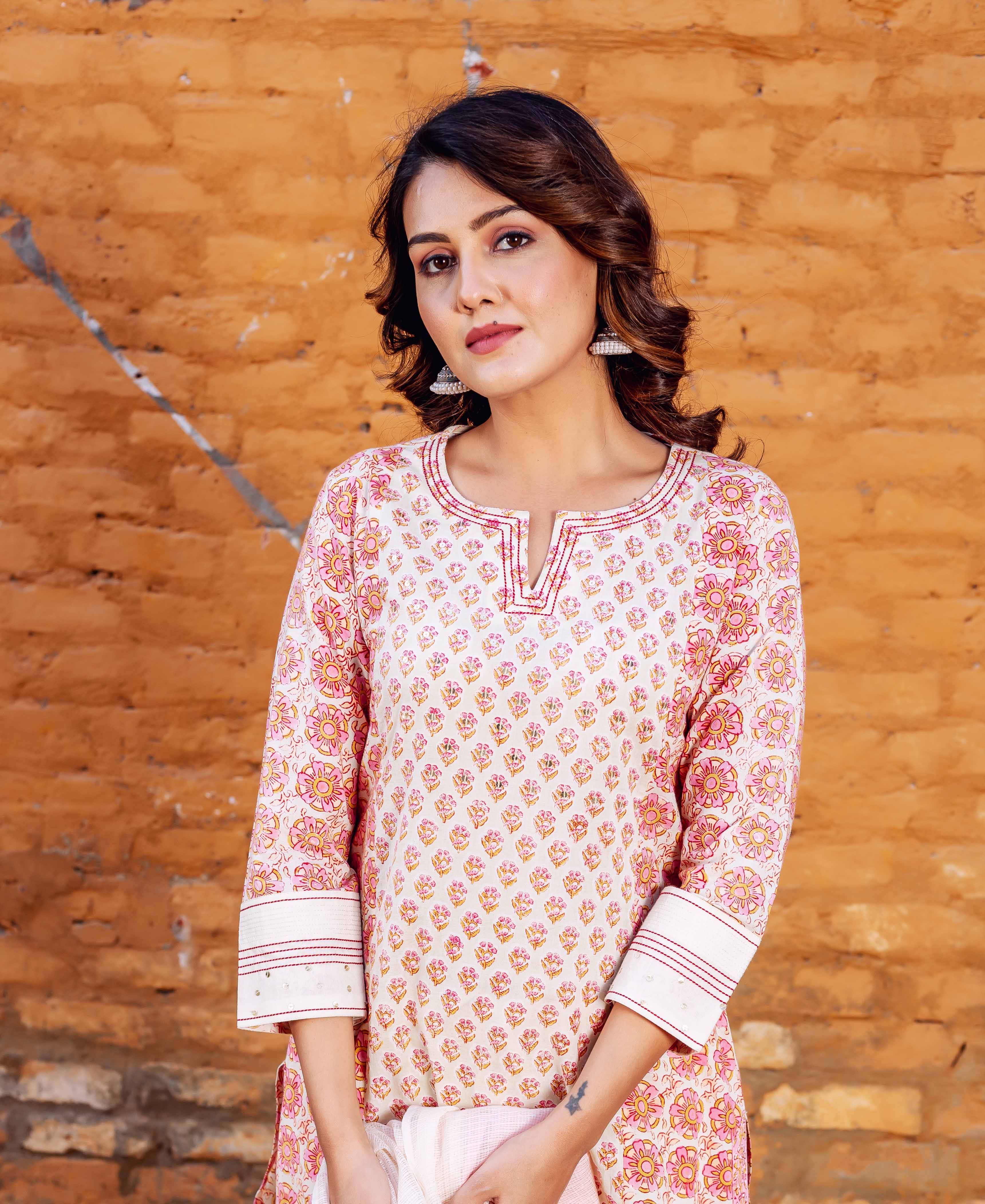 Front-facing model in cream Zoya cotton kurta, pink and yellow floral block print.