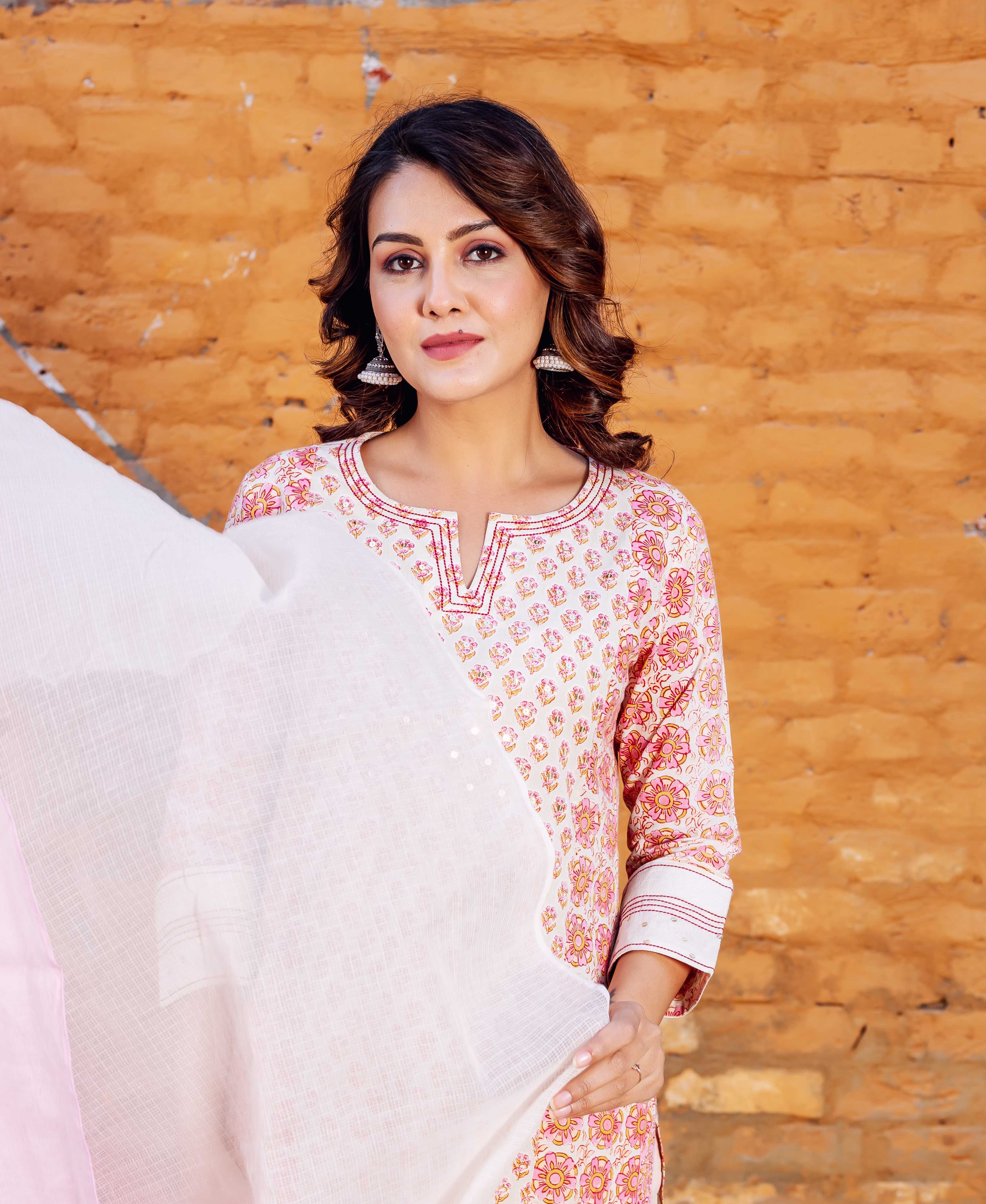 Front-facing woman in white, pink, orange floral block printed kurta with white dupatta.