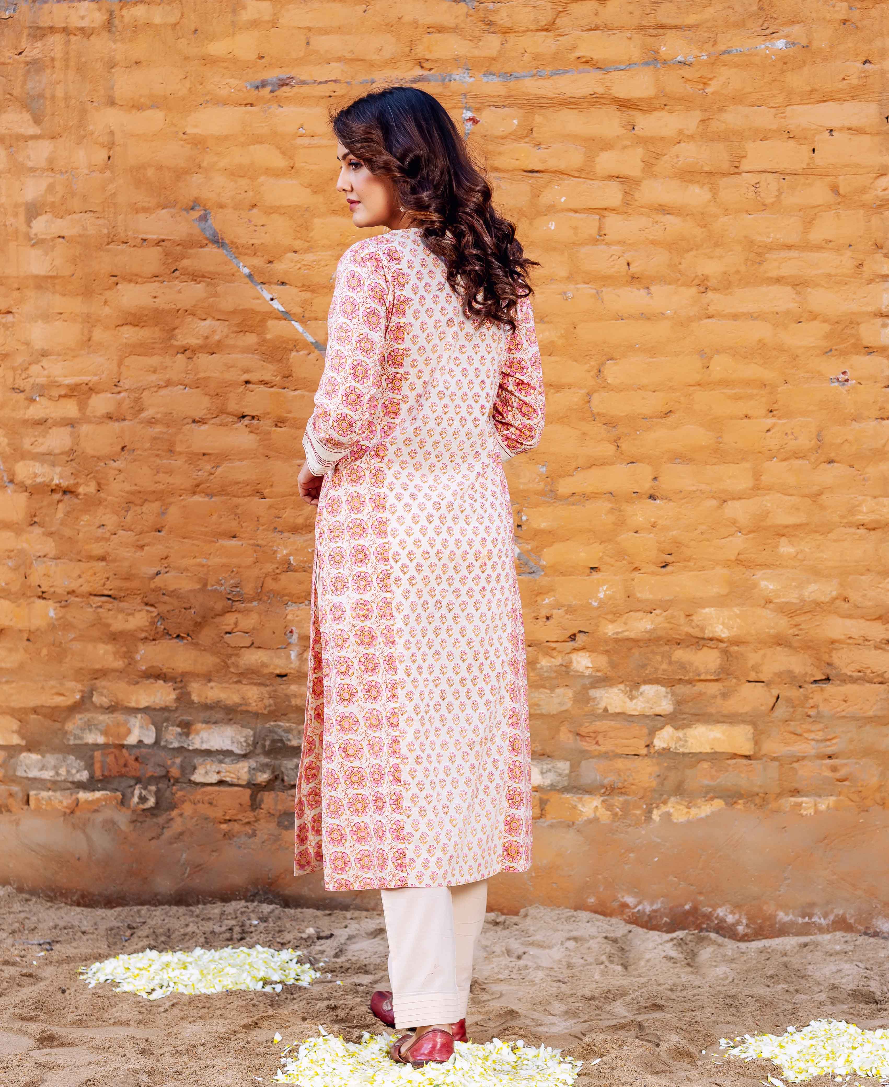 Model from back wearing cream cotton block printed straight kurta with pink pattern.