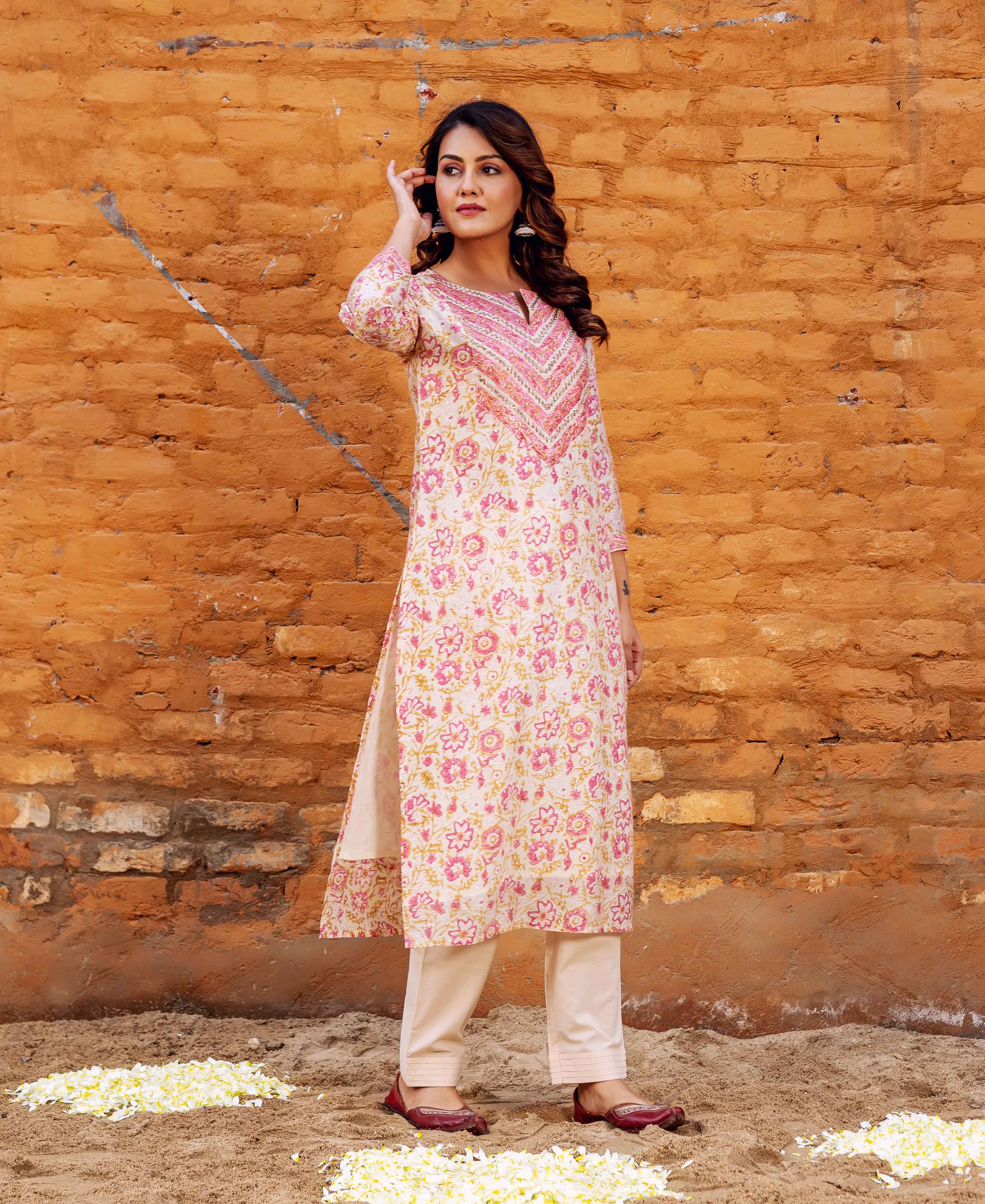 Model in a white Farah Chanderi straight kurta with pink and yellow floral block print.