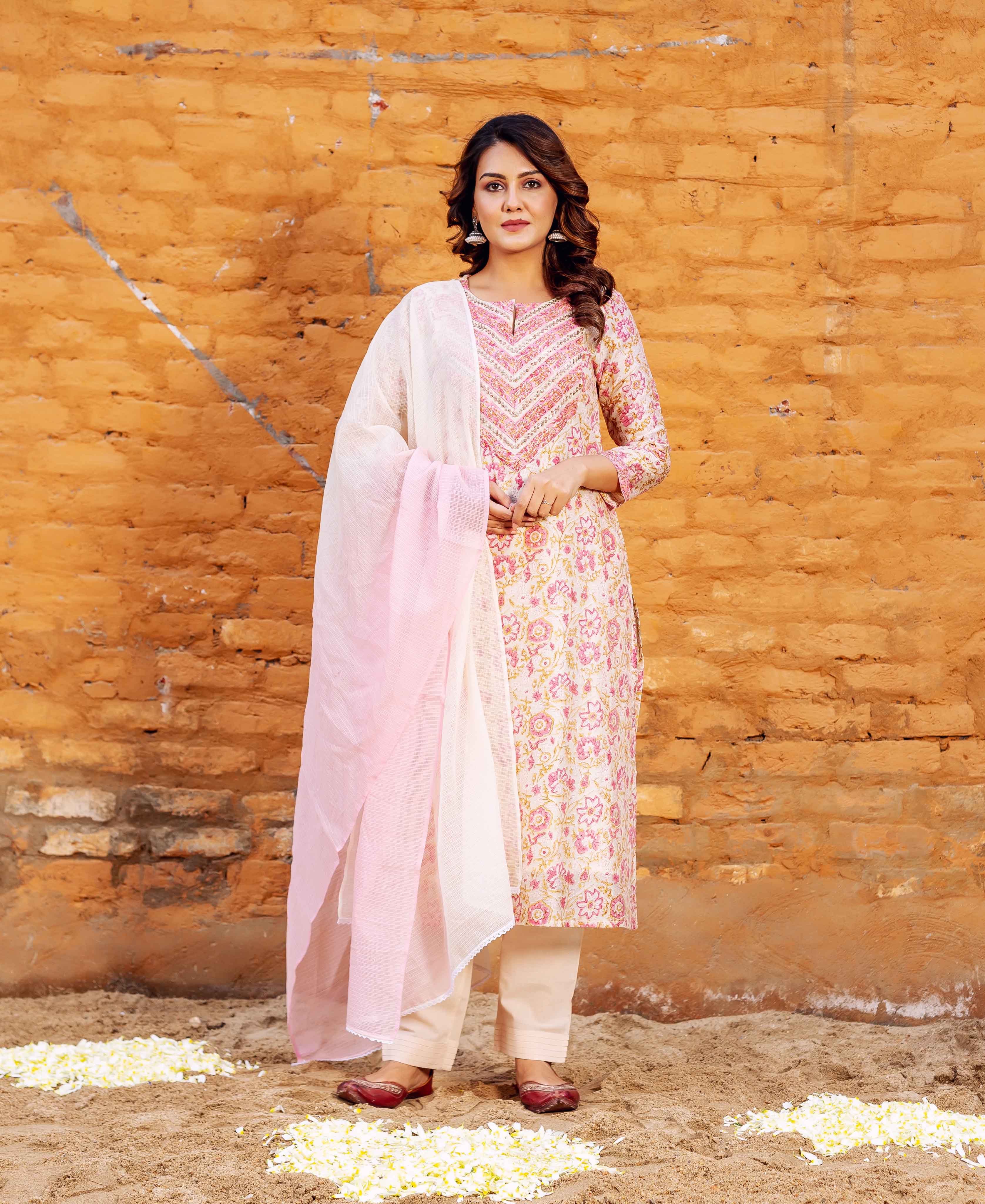 Model wearing a cream and pink floral block-printed straight kurta with an embroidered yoke.