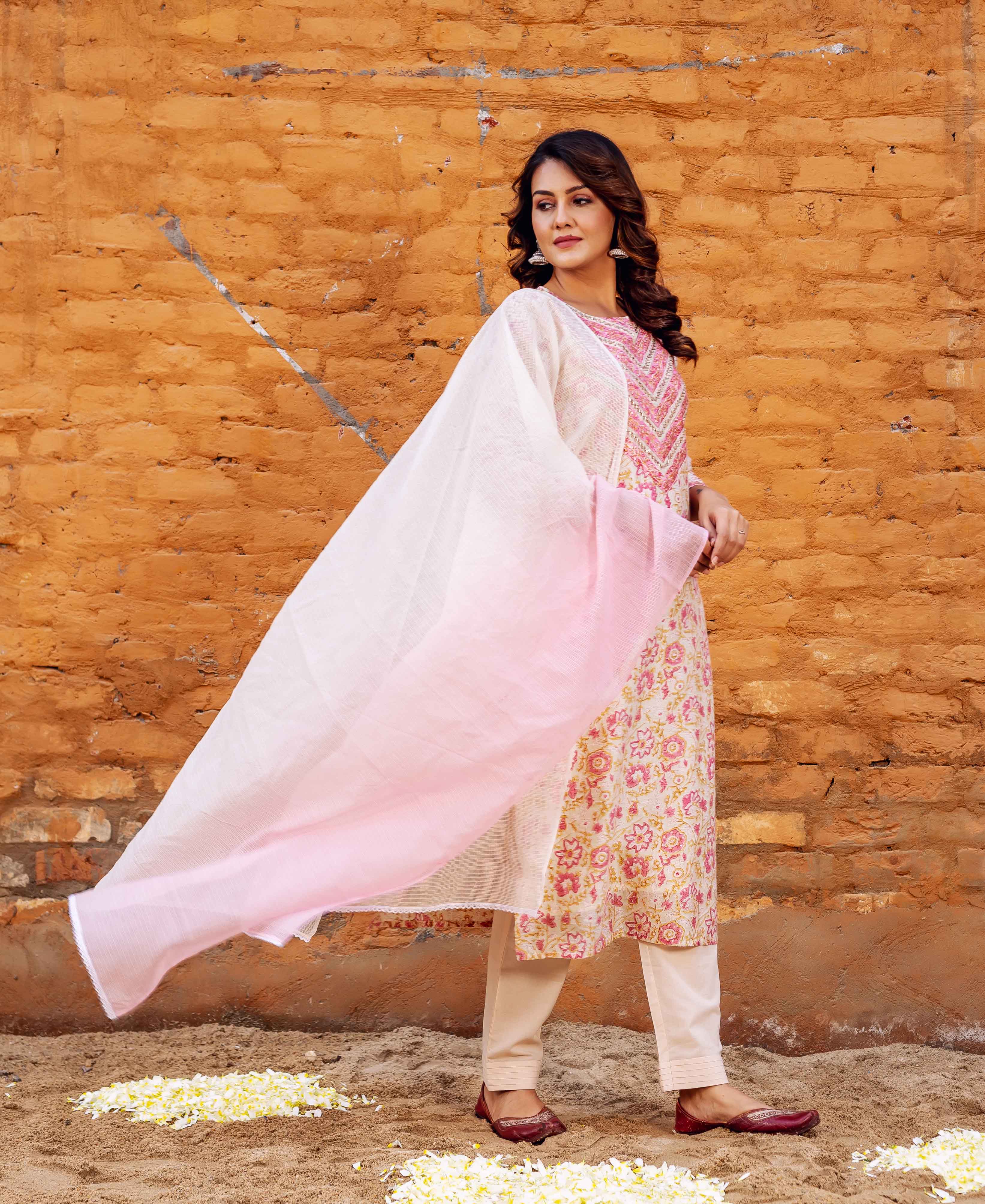 Model in cream floral block print kurta, straight pants, and flowing pink dupatta.