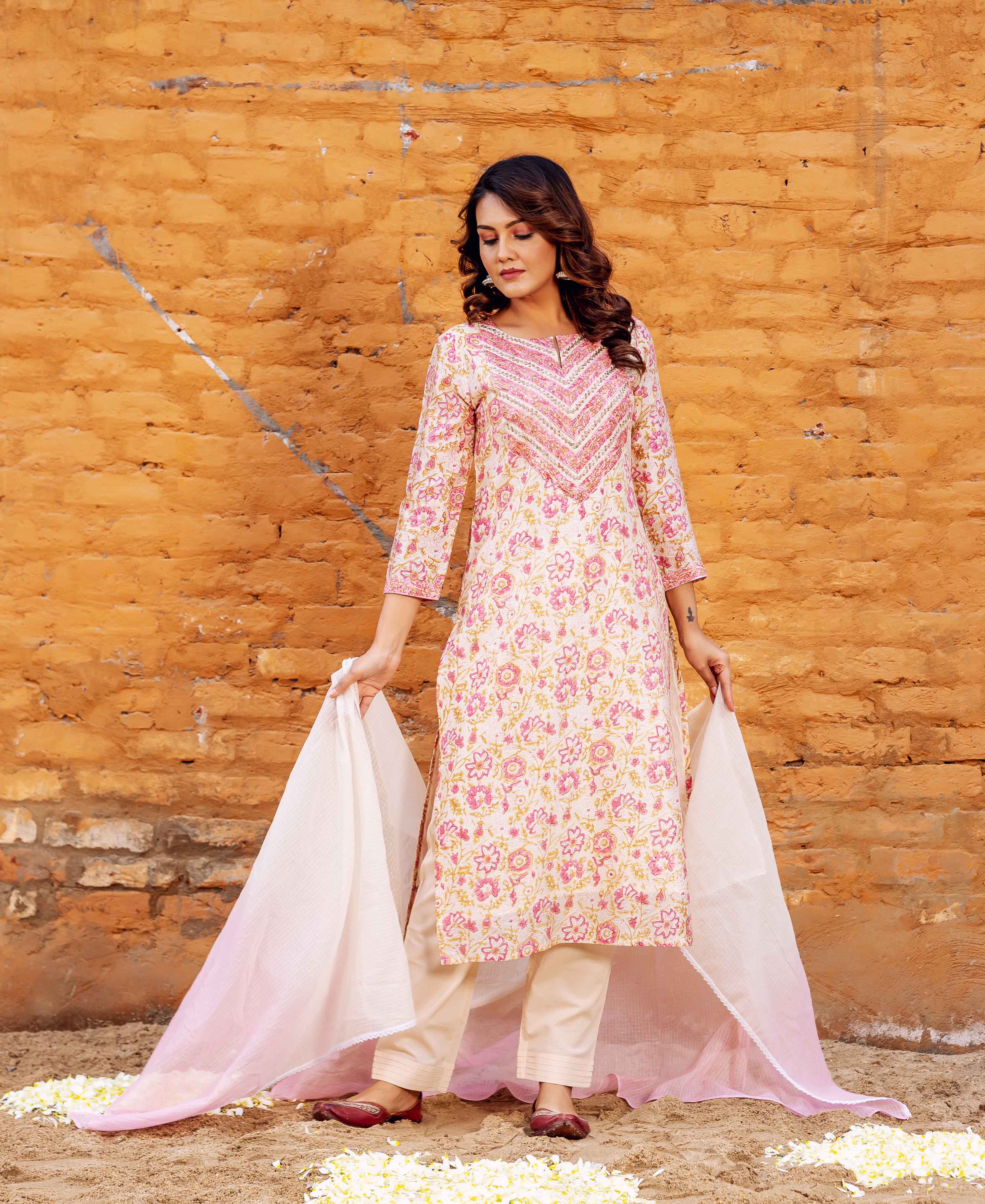 Model in cream and pink floral block printed straight kurta set with an embroidered neckline.