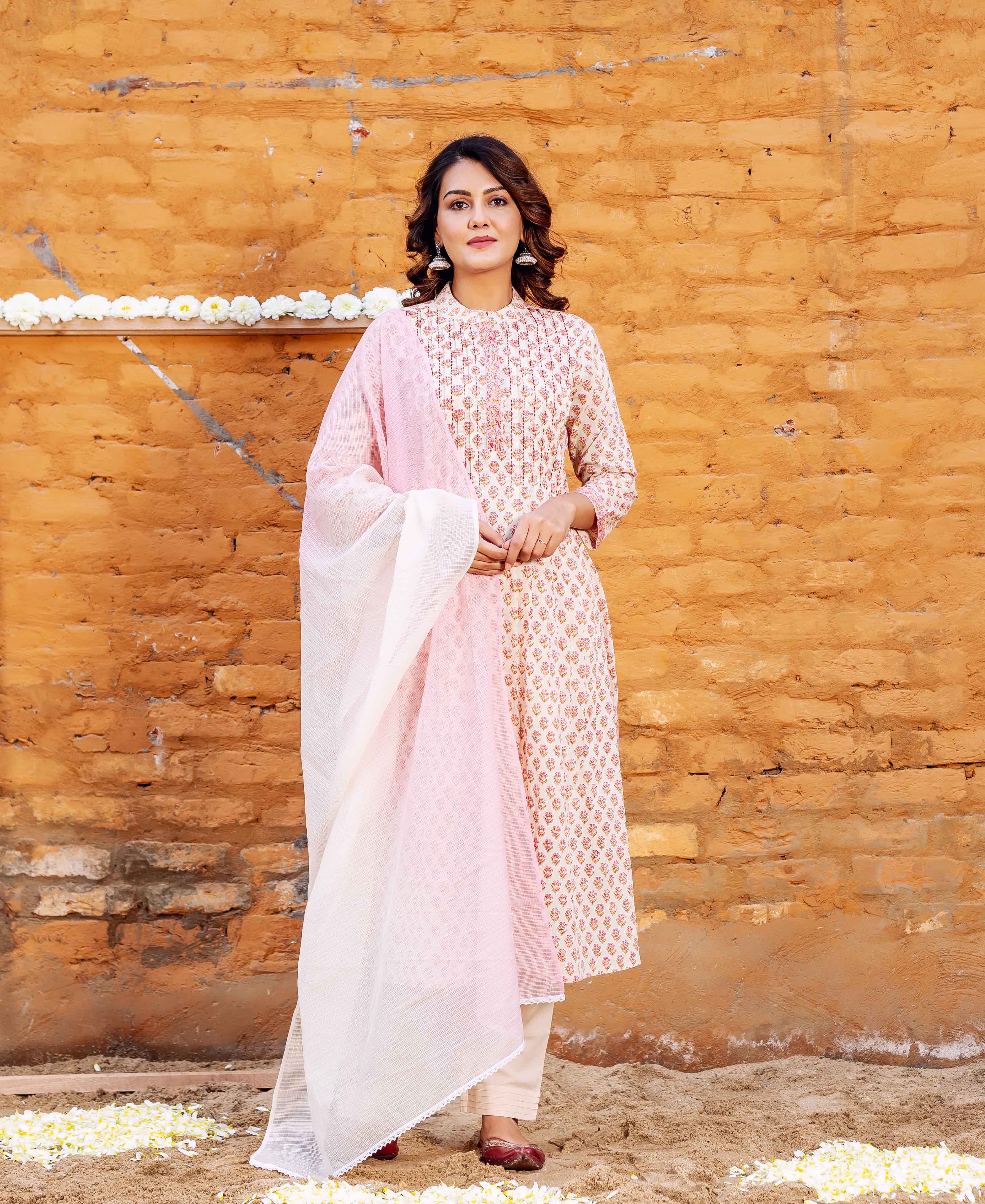 Full-length photo of woman in cream straight kurta with pink block print and sheer pink dupatta.