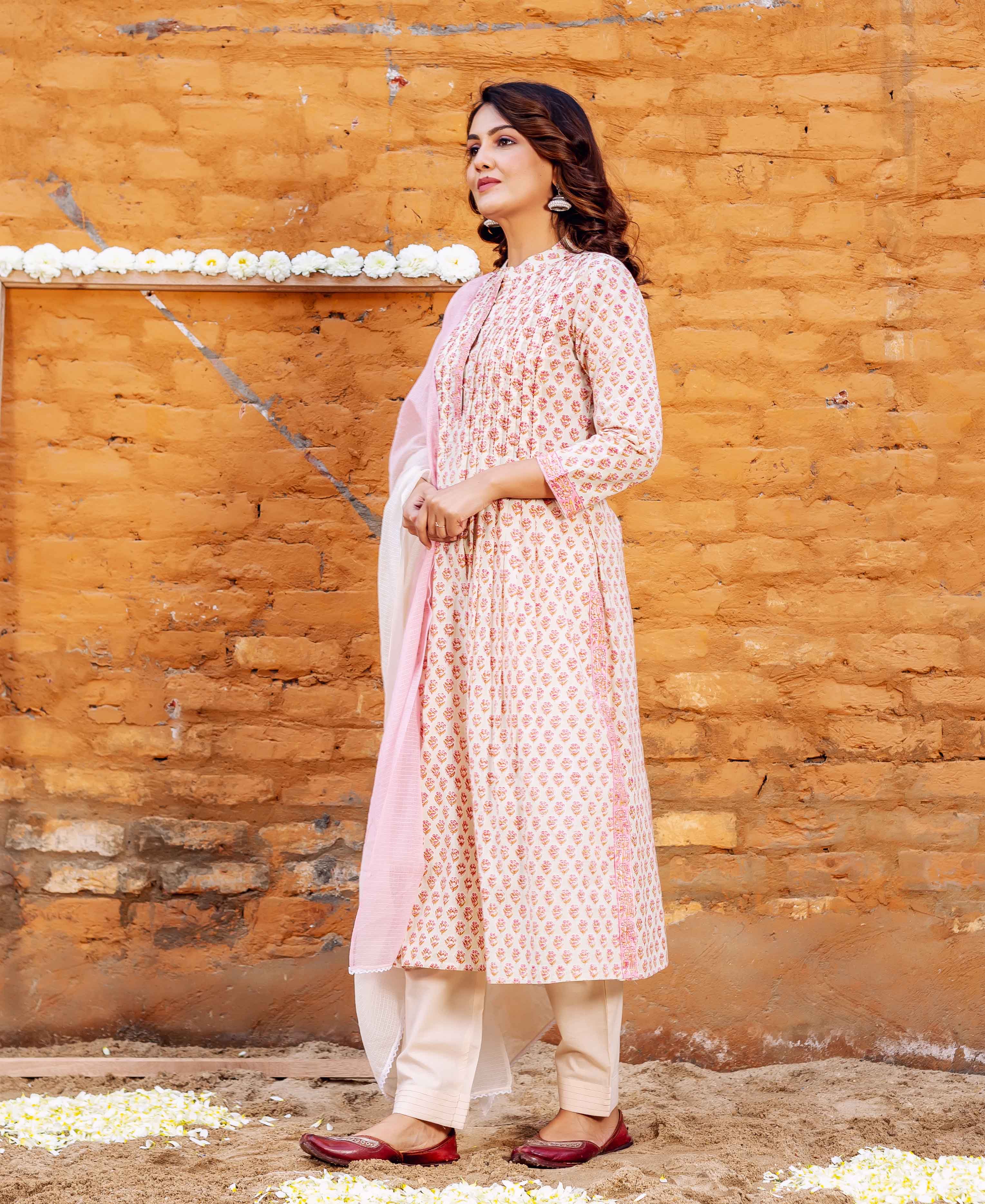 Side view model in cream block-printed straight cotton kurta, cream bottoms, pink dupatta.